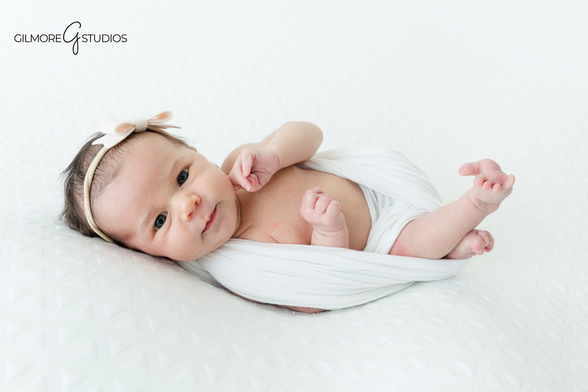 Awake newborn baby portrait with soft natural expression
Newborn detail photo with baby’s tiny hands and feet