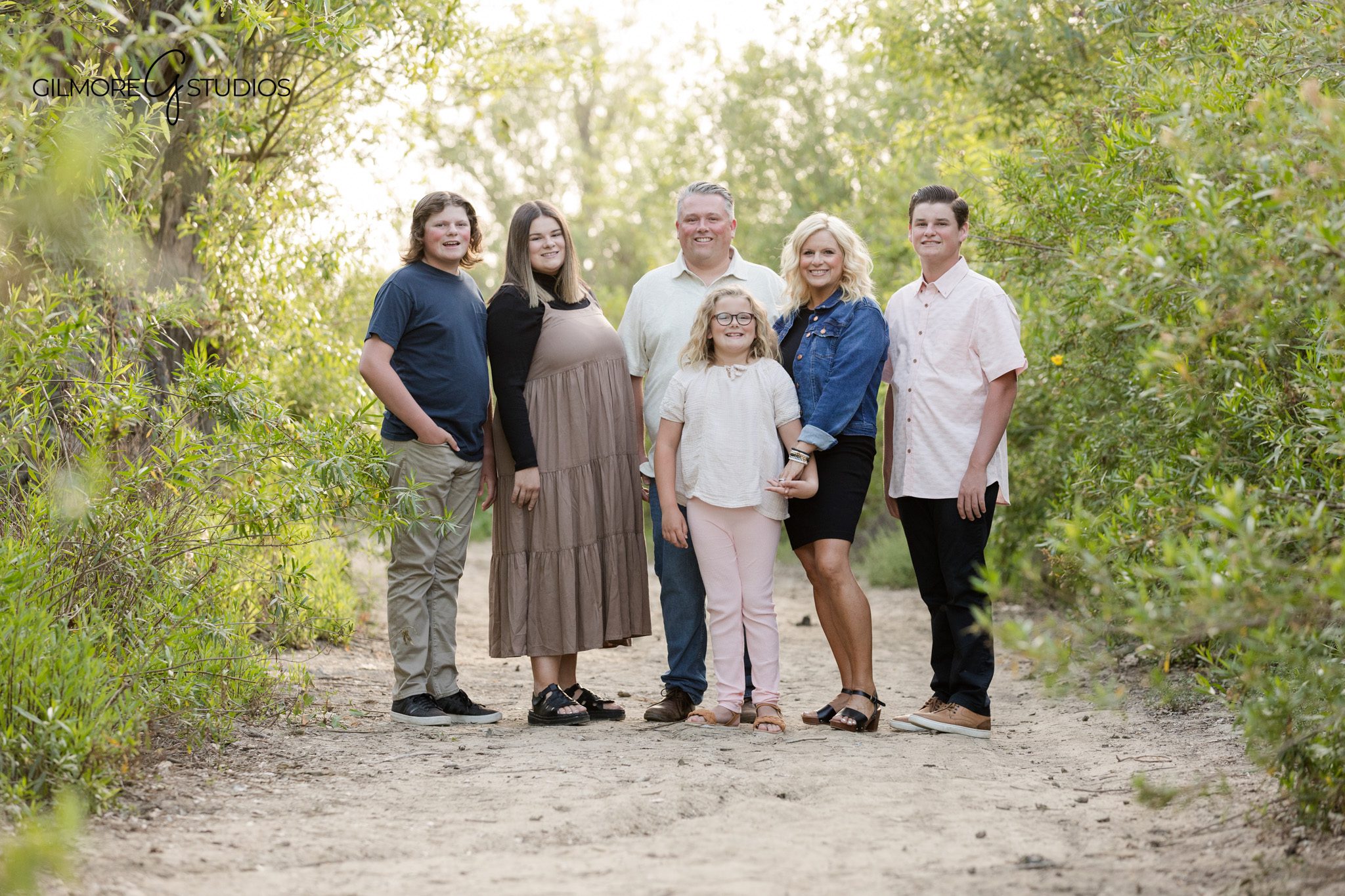 Outdoor family photos with soft greenery and warm evening light
19th Street Park family photos with natural connection and movement