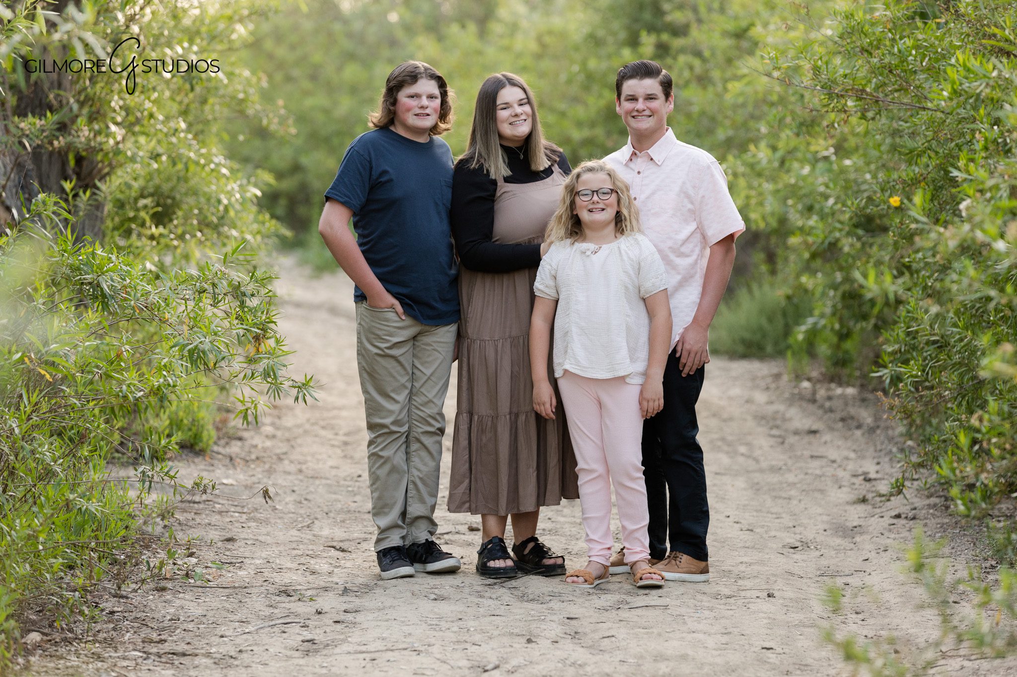 Family portraits in open grass at 19th Street Park during golden hour
Orange County family photographer capturing natural park portraits