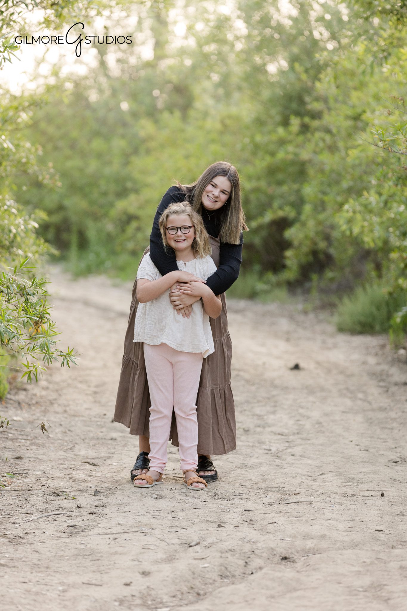 Family sitting together in the grass during 19th Street Park photos
Newport Beach outdoor family portraits with trees and natural light
