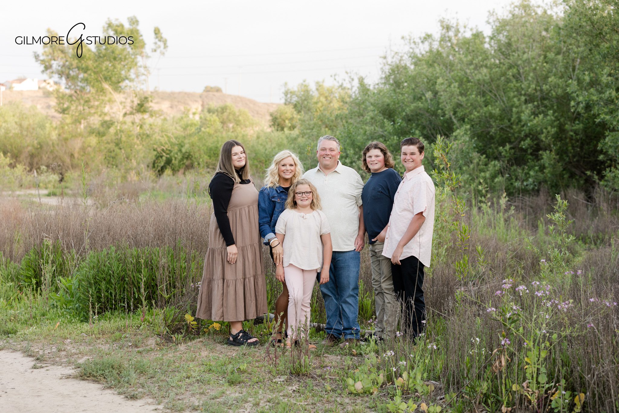 Family walking along a tree-lined trail at 19th Street Park
Golden hour family session at 19th Street Park in Newport Beach