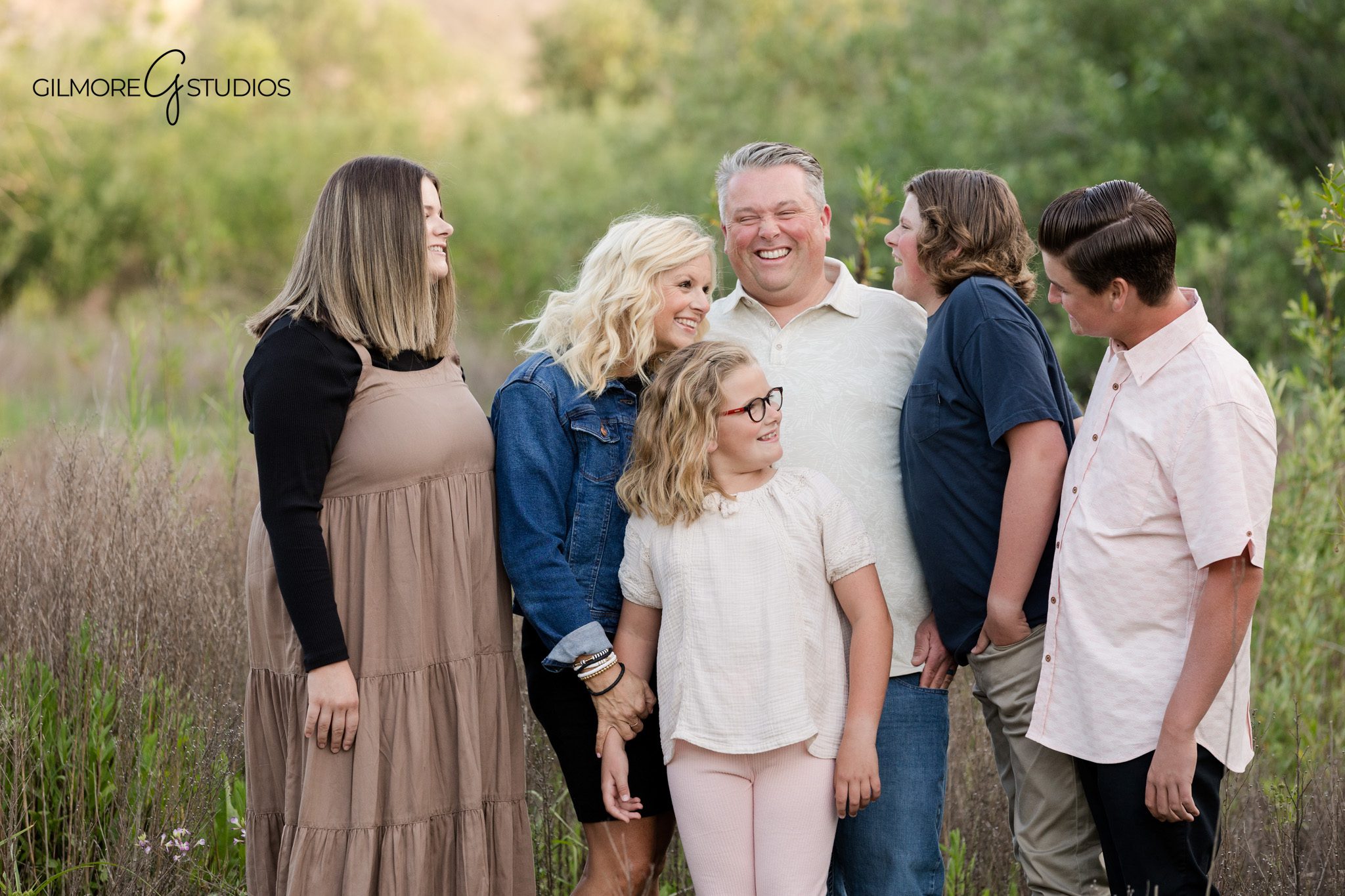 Outdoor family photos with trees and soft evening light at 19th Street Park
Siblings laughing together during a 19th Street Park family session