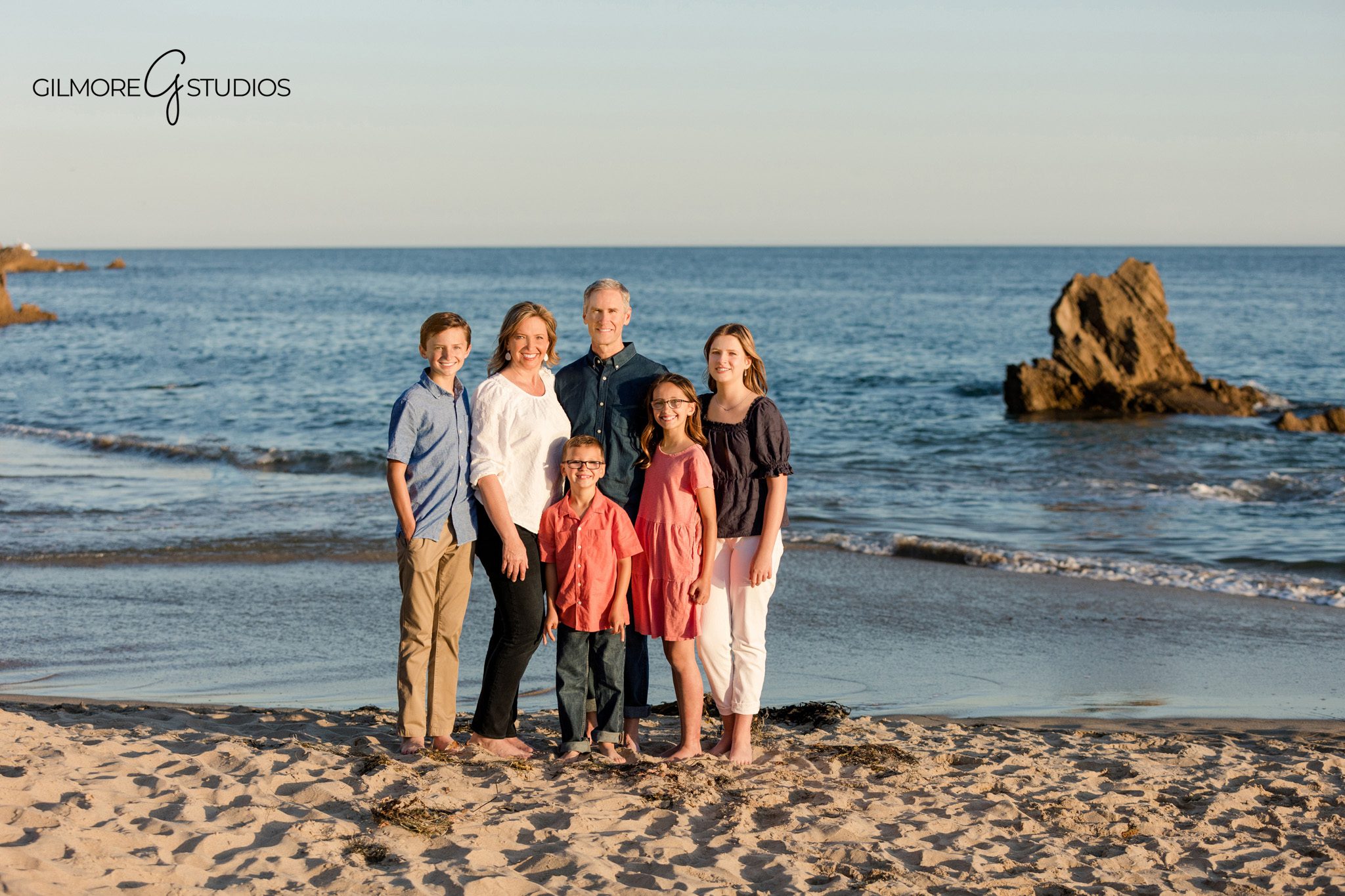 Grandparents and grandchildren laughing during Corona del Mar family session
Big Corona Beach golden hour family photography by Gilmore Studios