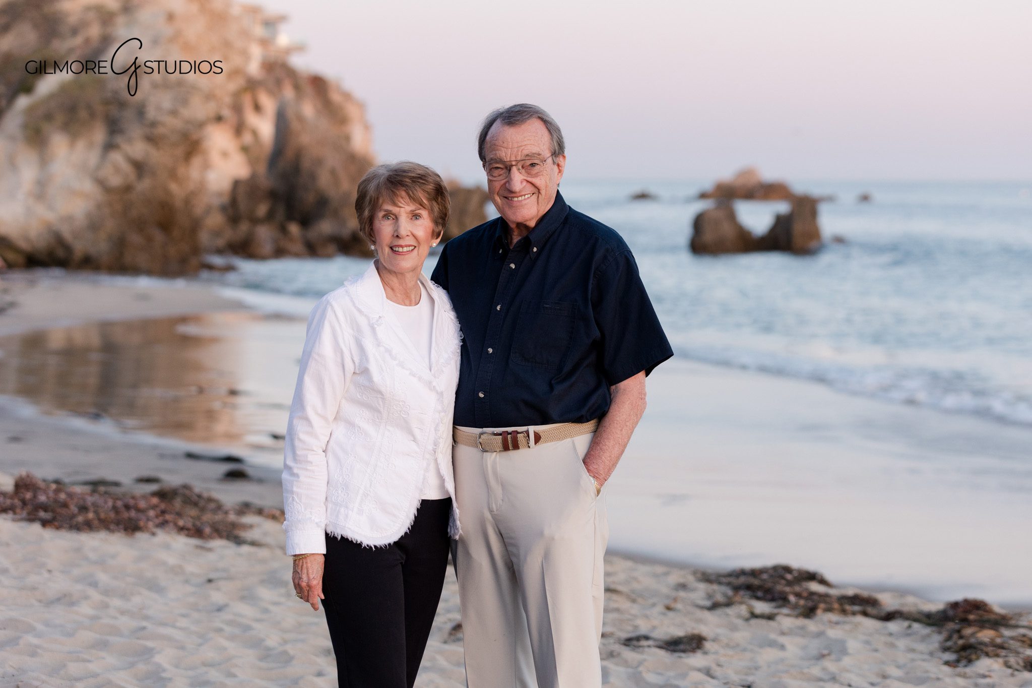 Grandparents sitting with grandchildren at Big Corona Beach
Multi-generational beach portraits with ocean and cliffs in Corona del Mar