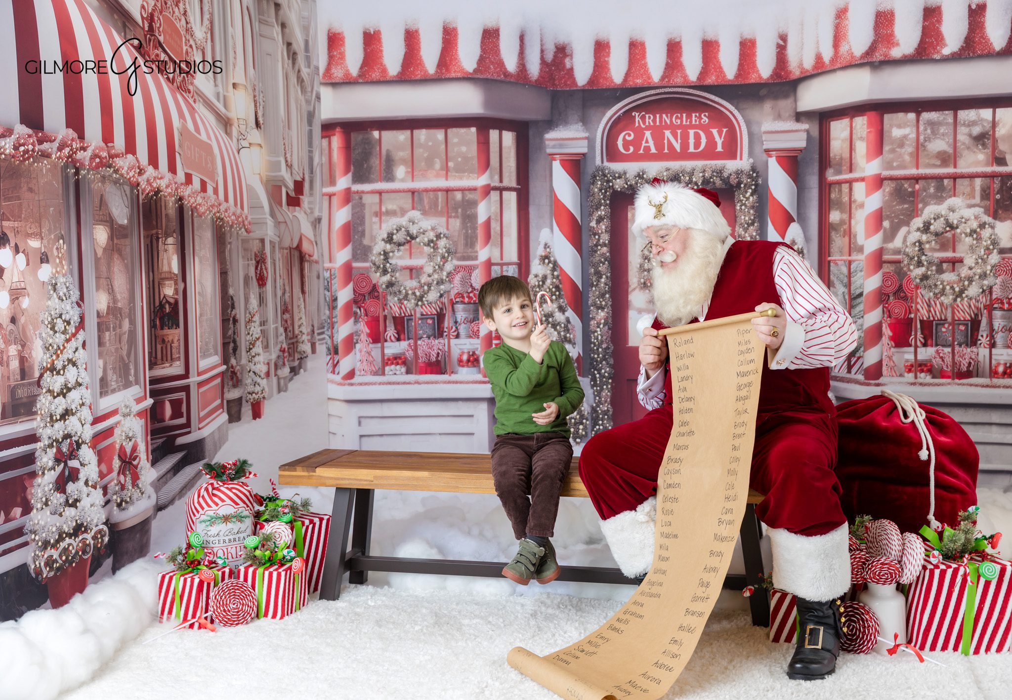 Children sitting with Santa during holiday mini session
Santa mini session with toddler and big brother in Christmas studio set