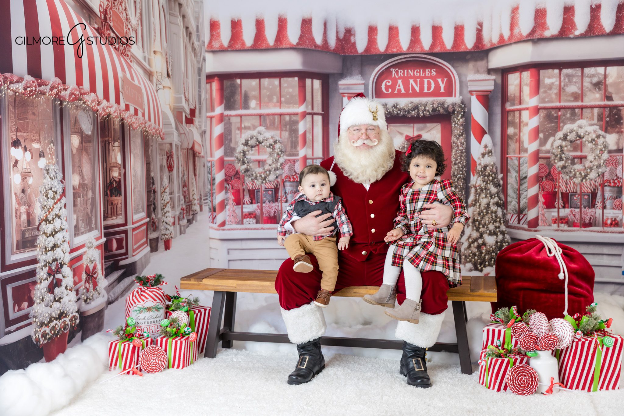Family Christmas photos with Santa at Gilmore Studios
Santa portrait session with parents and two young boys