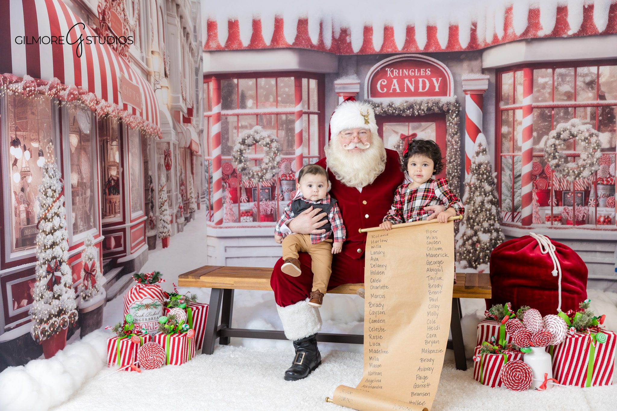 Holiday portrait of child sitting on Santa’s lap
Santa Experience with book and candy shop backdrop