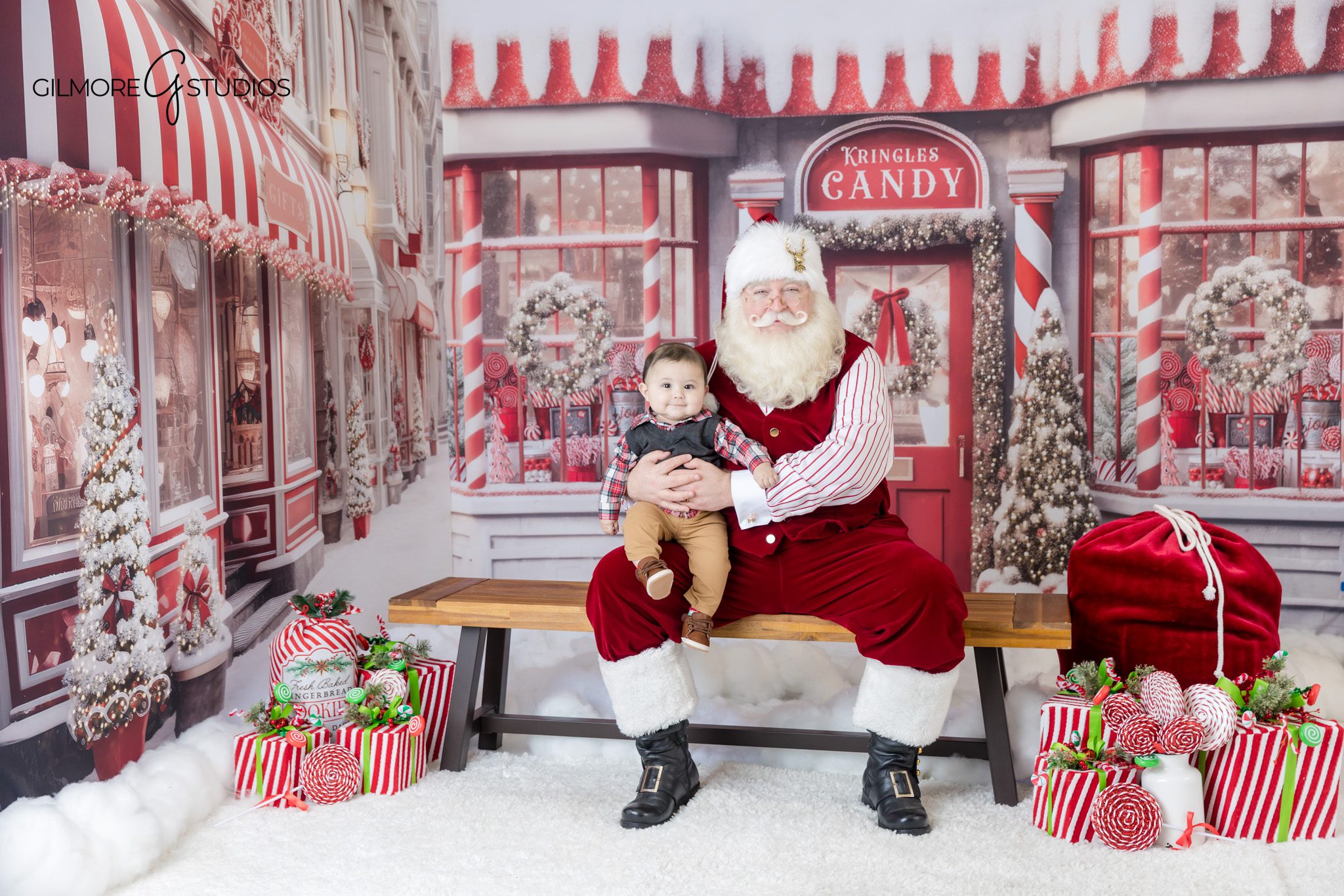 Santa sharing cookies during holiday mini session
Child holding cookie with Santa in Christmas studio set