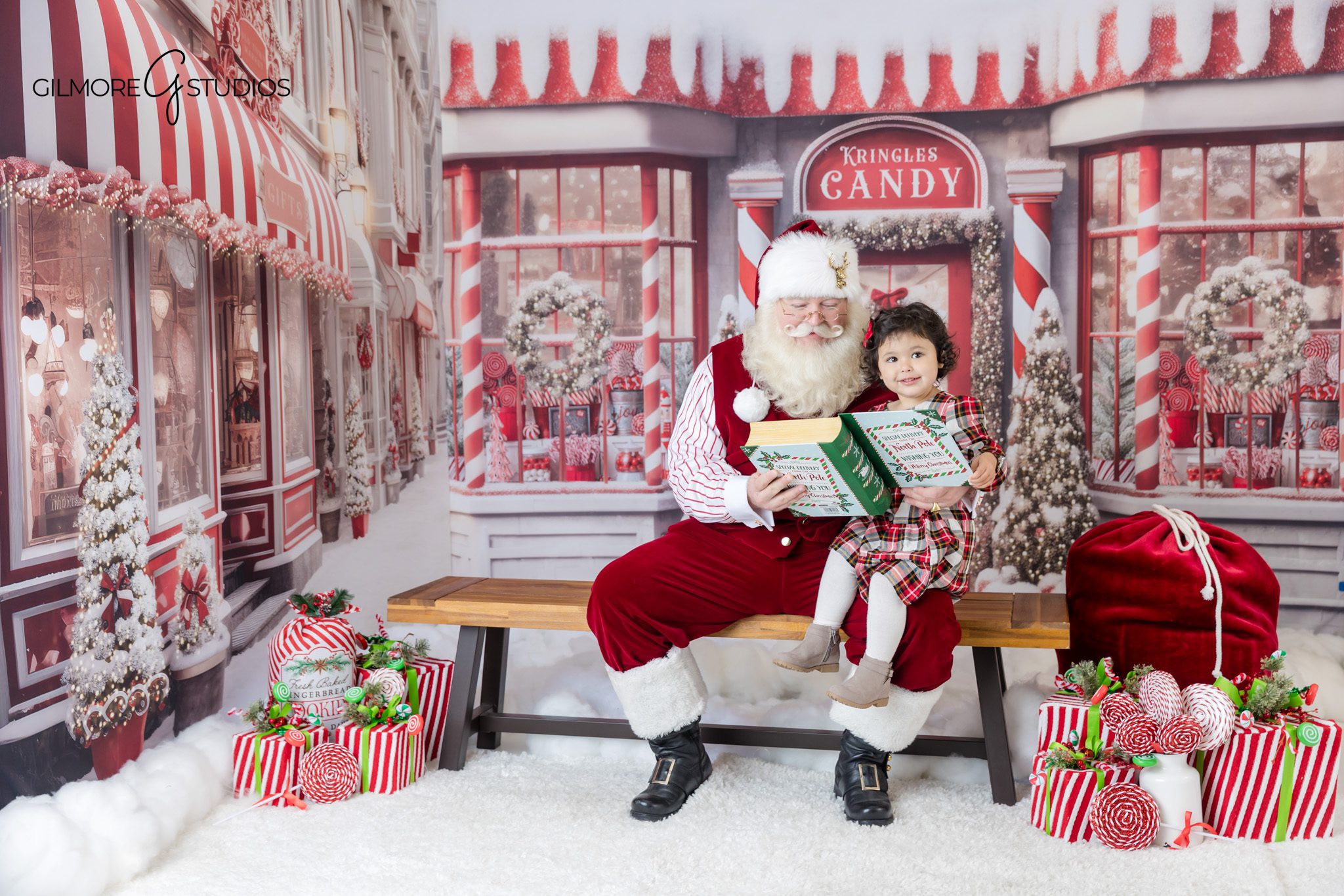 Santa mini session with cookie moment and candy shop backdrop
Candid Christmas portrait with Santa and young child