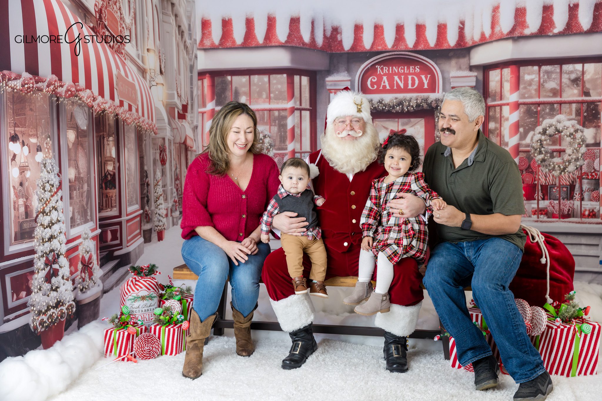 Christmas candy shop Santa mini session for family photos
Holiday family portrait with Santa in red and white Christmas set