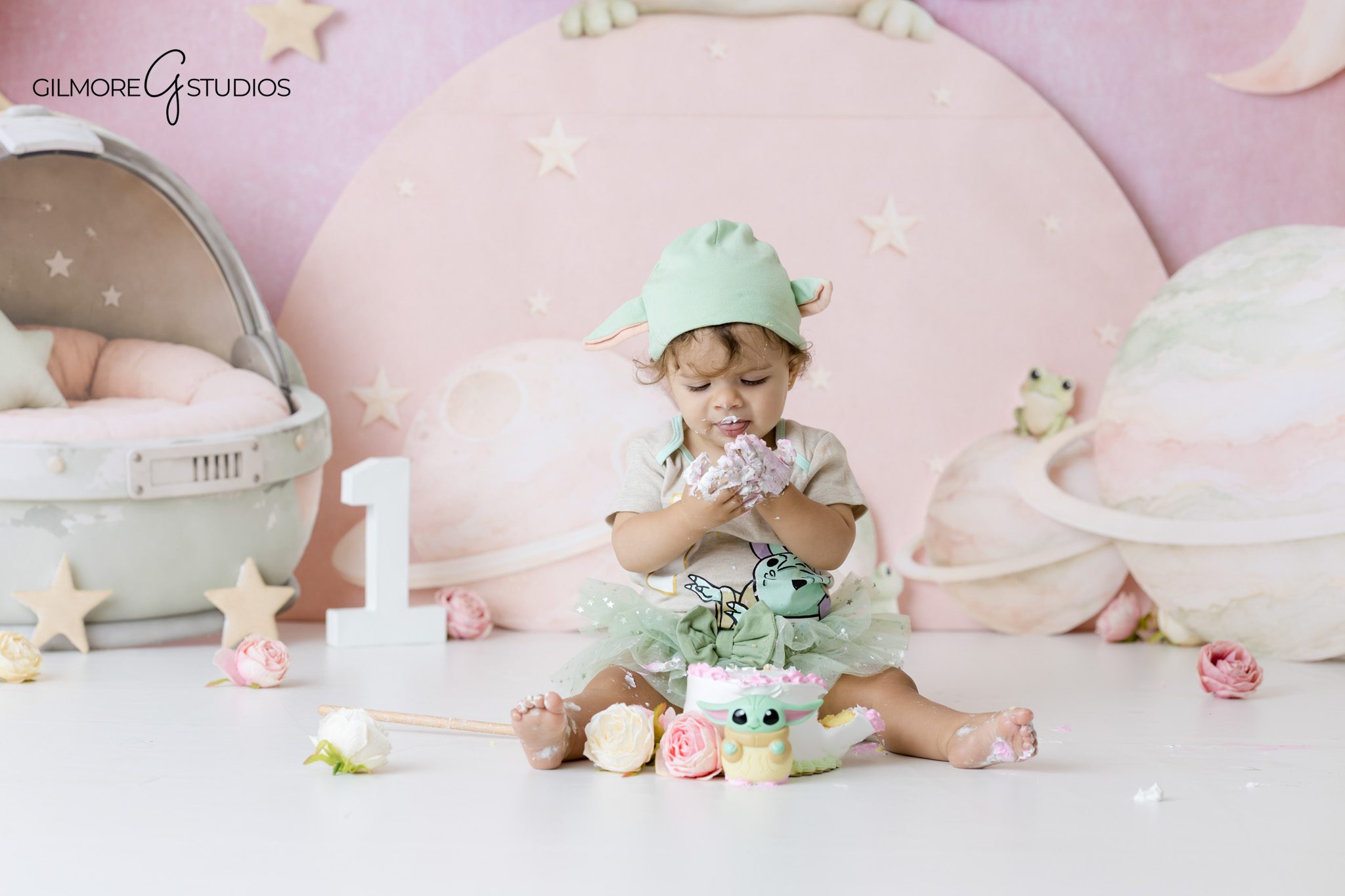 Gilmore Studios photographing a Baby Yoda cake smash in Newport Beach
Baby girl crawling through her Baby Yoda first birthday setup before the cake