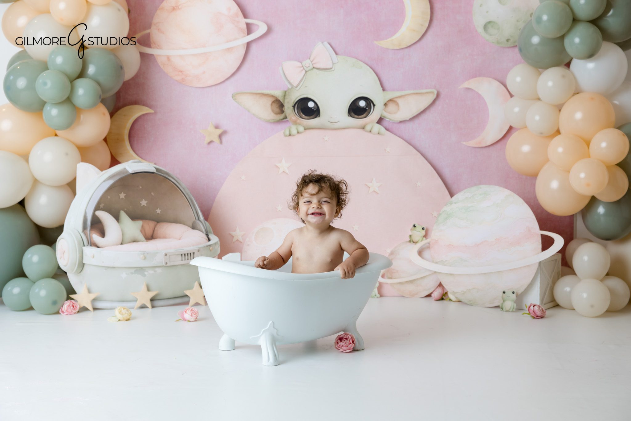 Baby Yoda themed cake smash with baby holding frosting on her hands
Grogu inspired birthday photos for one year old baby at Gilmore Studios