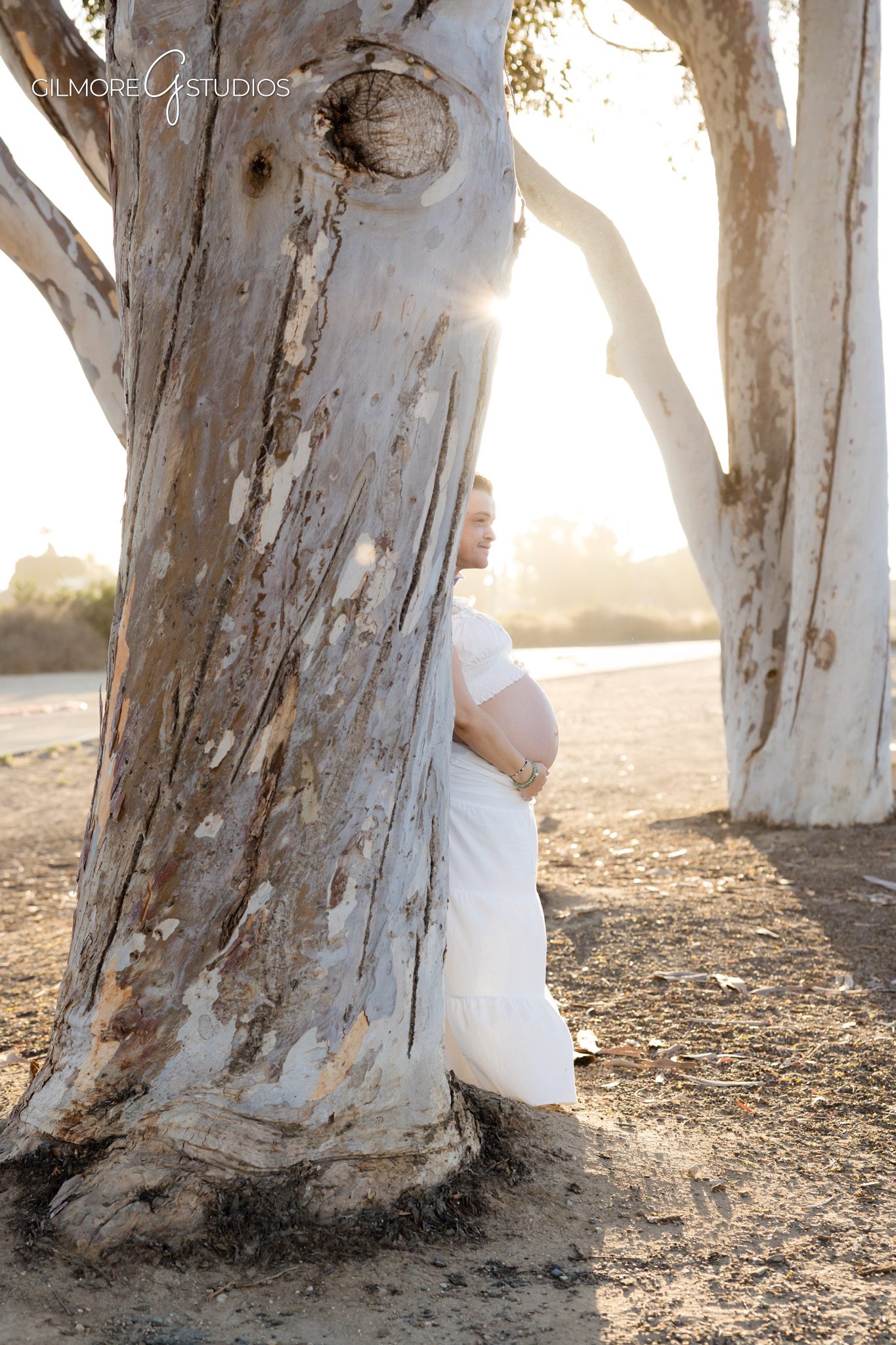 Surprise proposal photography during maternity session at the Back Bay
Expecting couple embracing after proposal at Newport Beach Back Bay