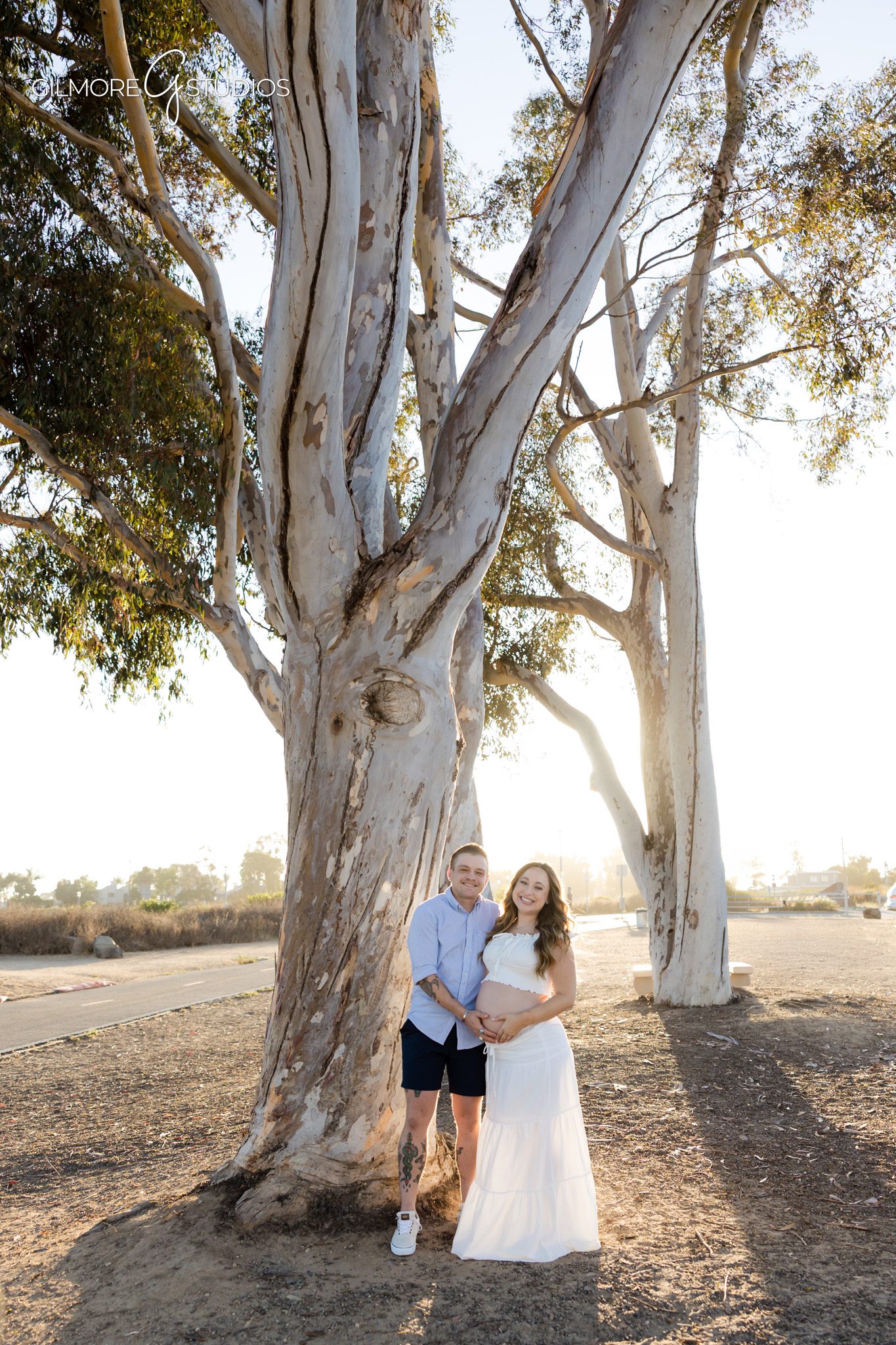 Back Bay maternity session with couple walking under eucalyptus trees
Surprise proposal during pregnancy photos in Newport Beach California