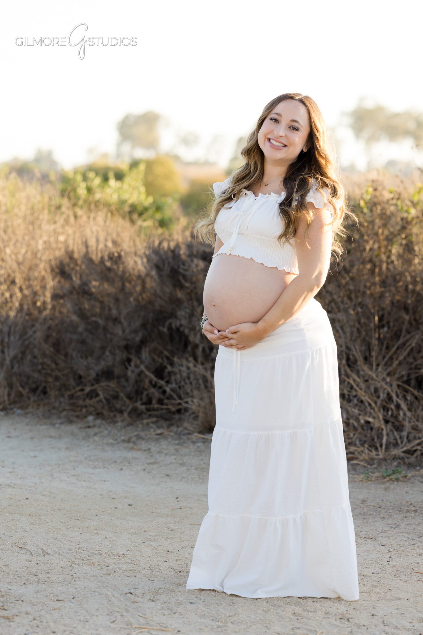 Expecting couple hugging after surprise proposal during maternity session
Maternity and engagement portraits during one Newport Beach photo session
