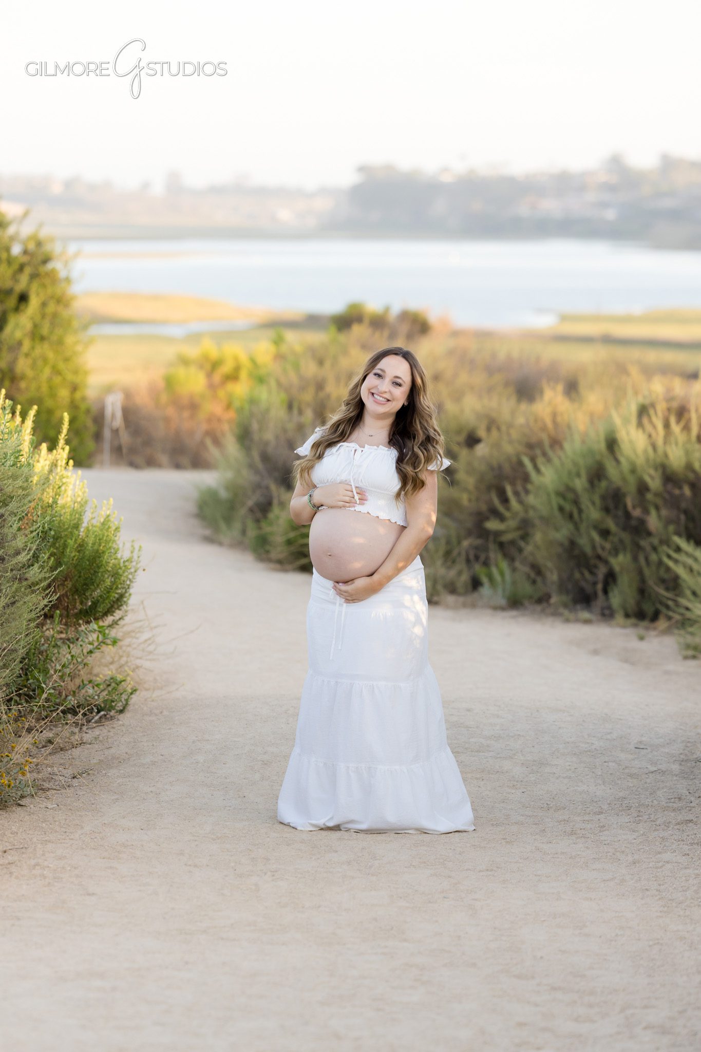 Newport Beach maternity proposal with soft light and natural background
Expecting mother covering face during surprise proposal at Back Bay