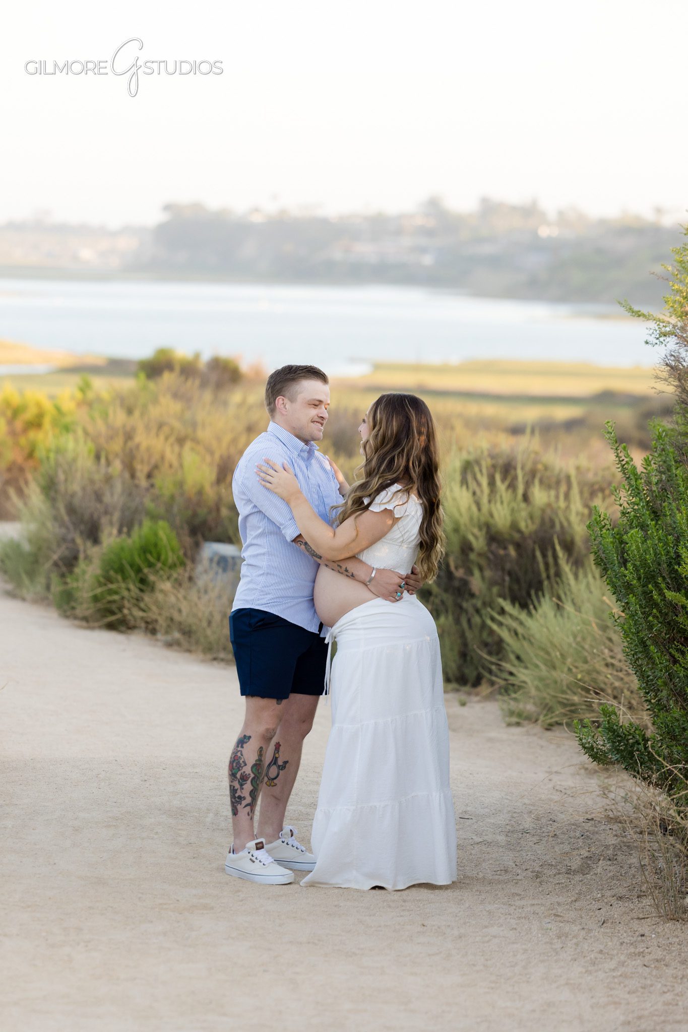 Gilmore Studios photographing a Newport Beach maternity proposal session
Couple walking on Back Bay trail before surprise proposal
