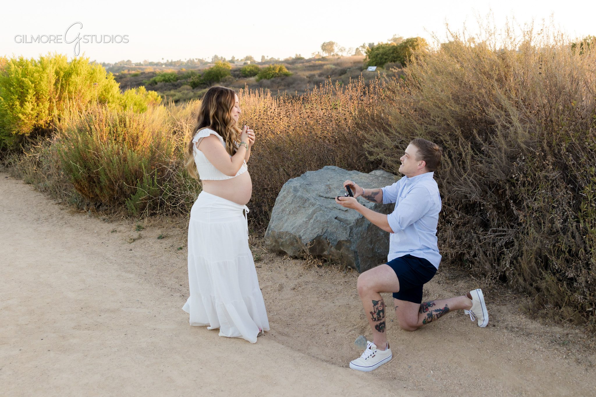 Back Bay proposal photos with expecting parents near the water
Couple laughing after surprise proposal during Newport Beach maternity session