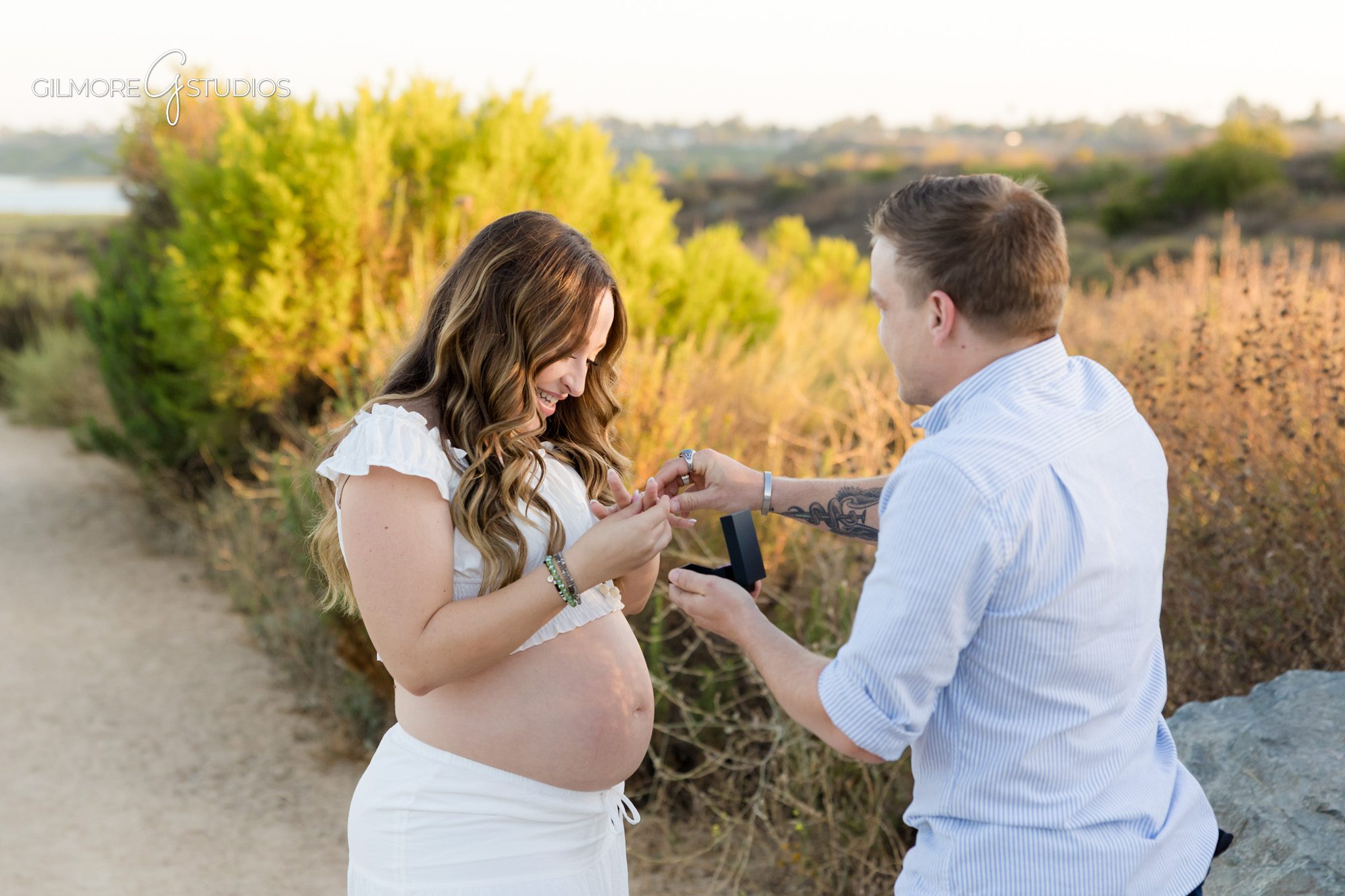 Gilmore Studios maternity session with surprise proposal in Newport Beach
Couple embracing under eucalyptus trees after Back Bay proposal