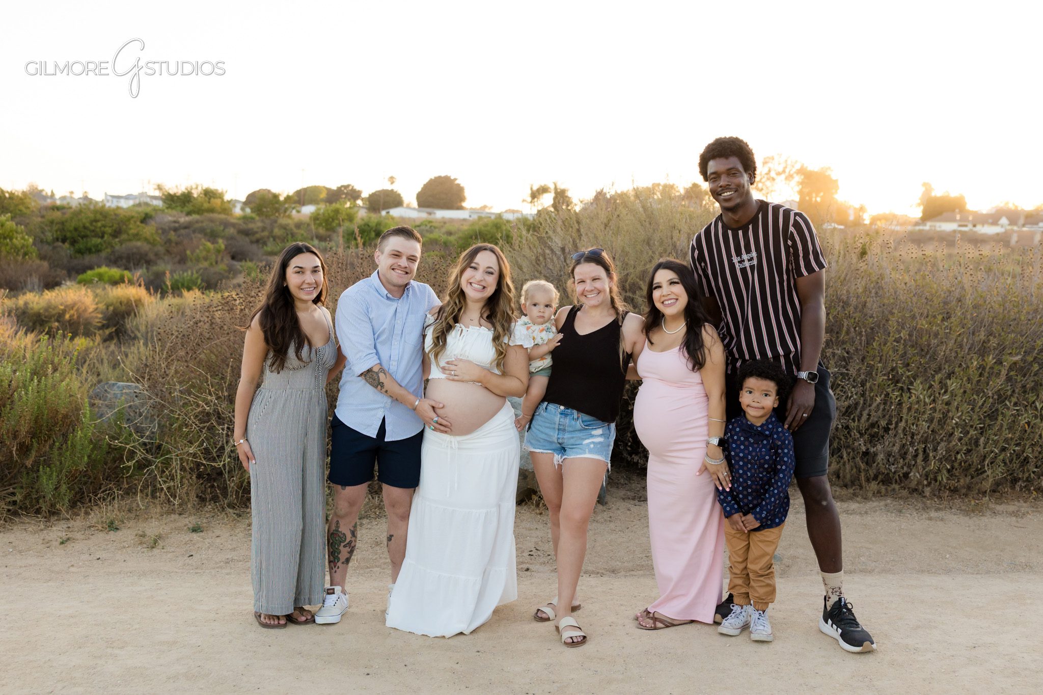 Expecting parents smiling together after surprise engagement in Newport Beach
Maternity proposal session with baby shoes and engagement ring detail