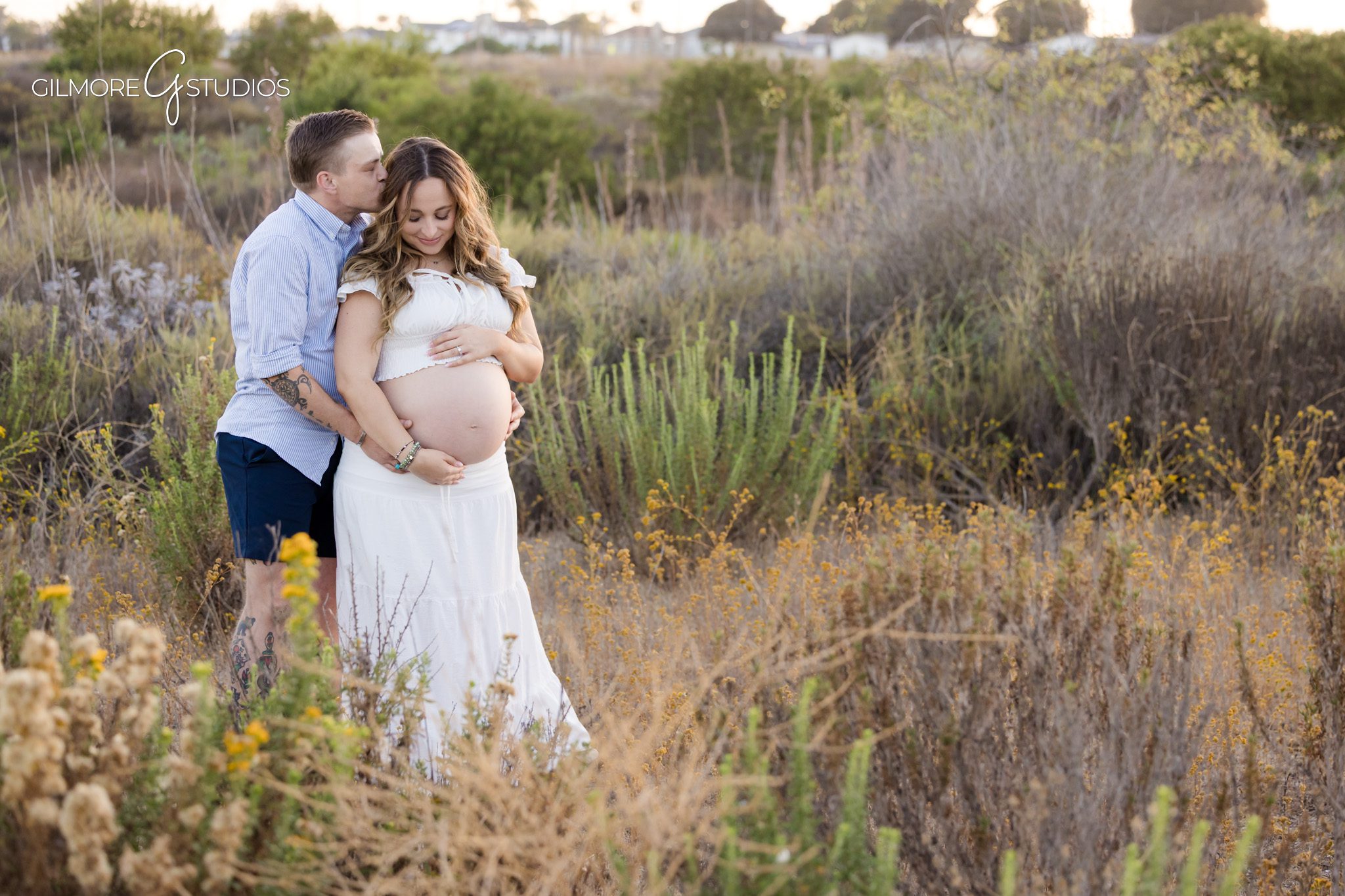 Newport Beach surprise proposal photographer capturing candid reaction
Couple celebrating baby on the way and engagement at Back Bay