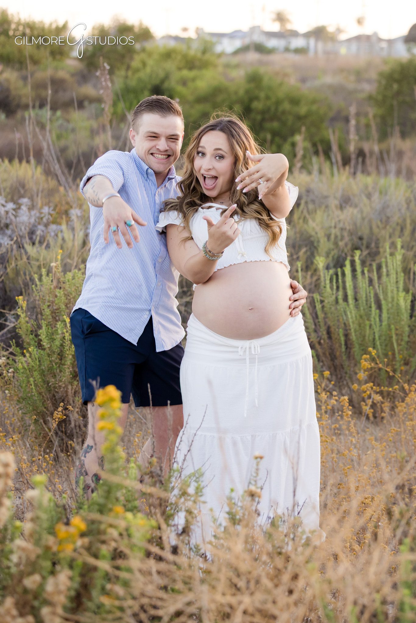 Expecting mother looking at engagement ring after proposal at Back Bay
Newport Beach maternity proposal photos with natural trail scenery