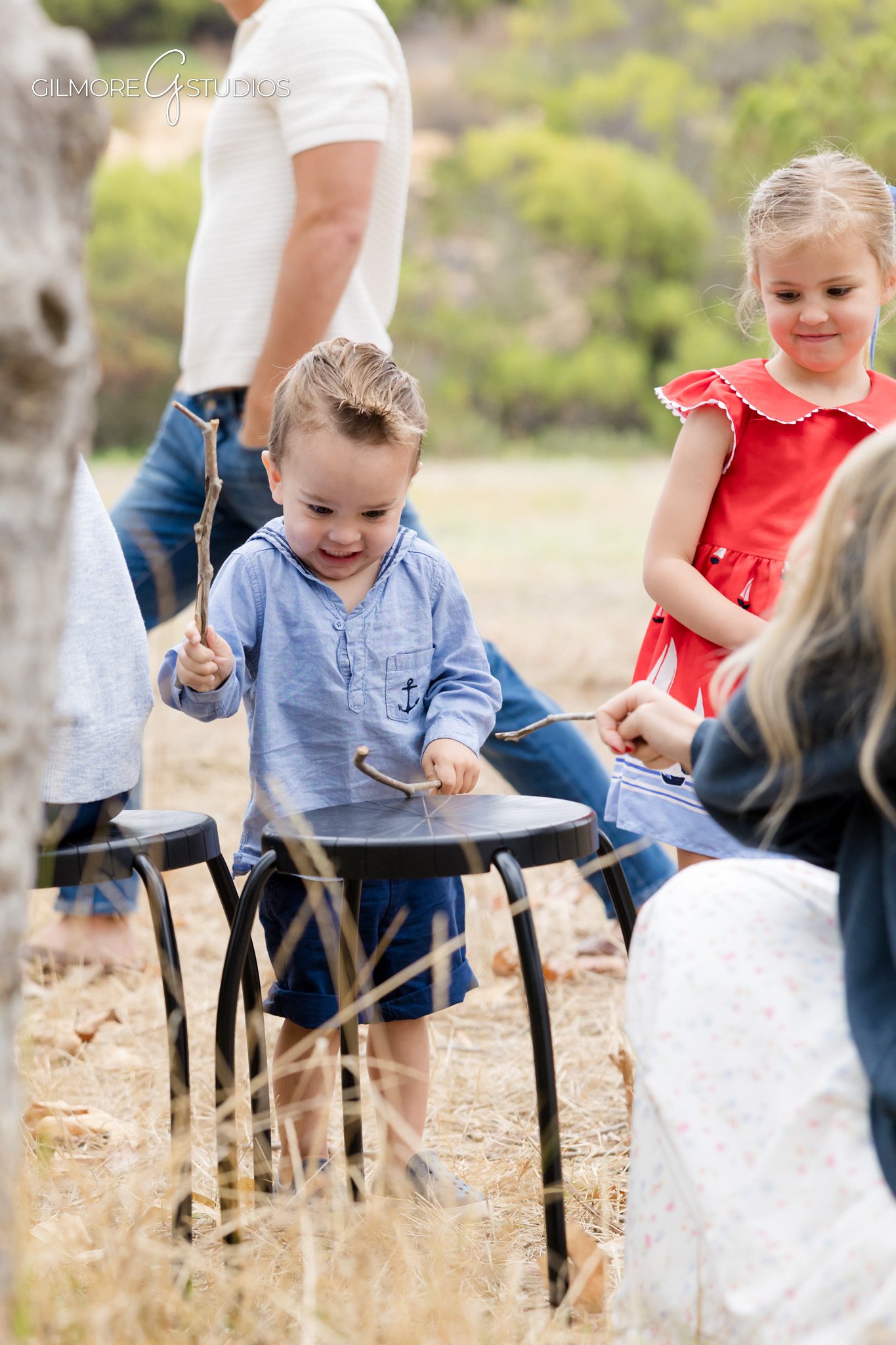 Extended family photos with grandparents and grandchildren sitting together at Canyon Park
Large multigenerational family portrait with soft outdoor light in Costa Mesa