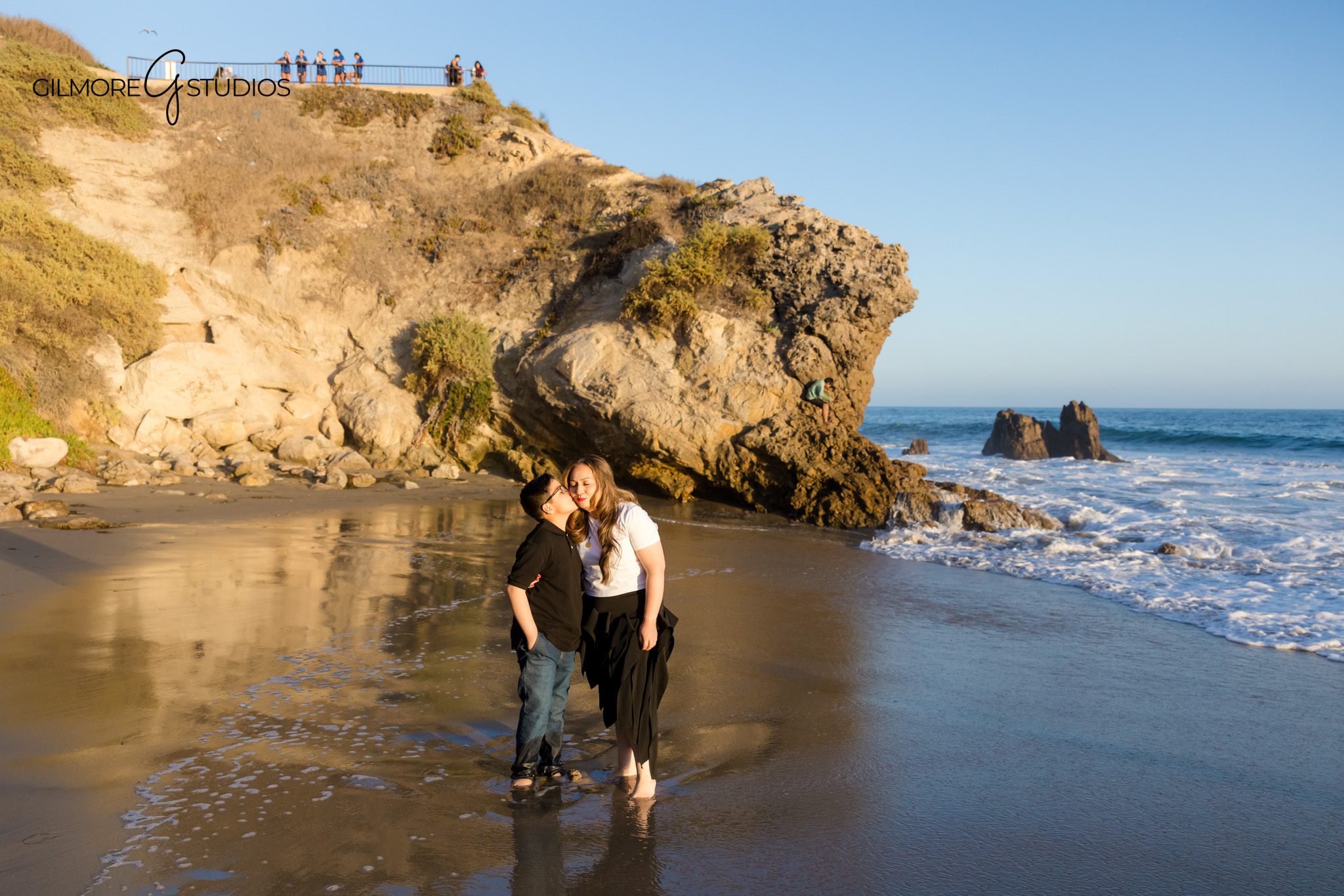 Big Corona Beach photos with parents and child watching the waves
Corona del Mar family photos with wet sand reflections at sunset
