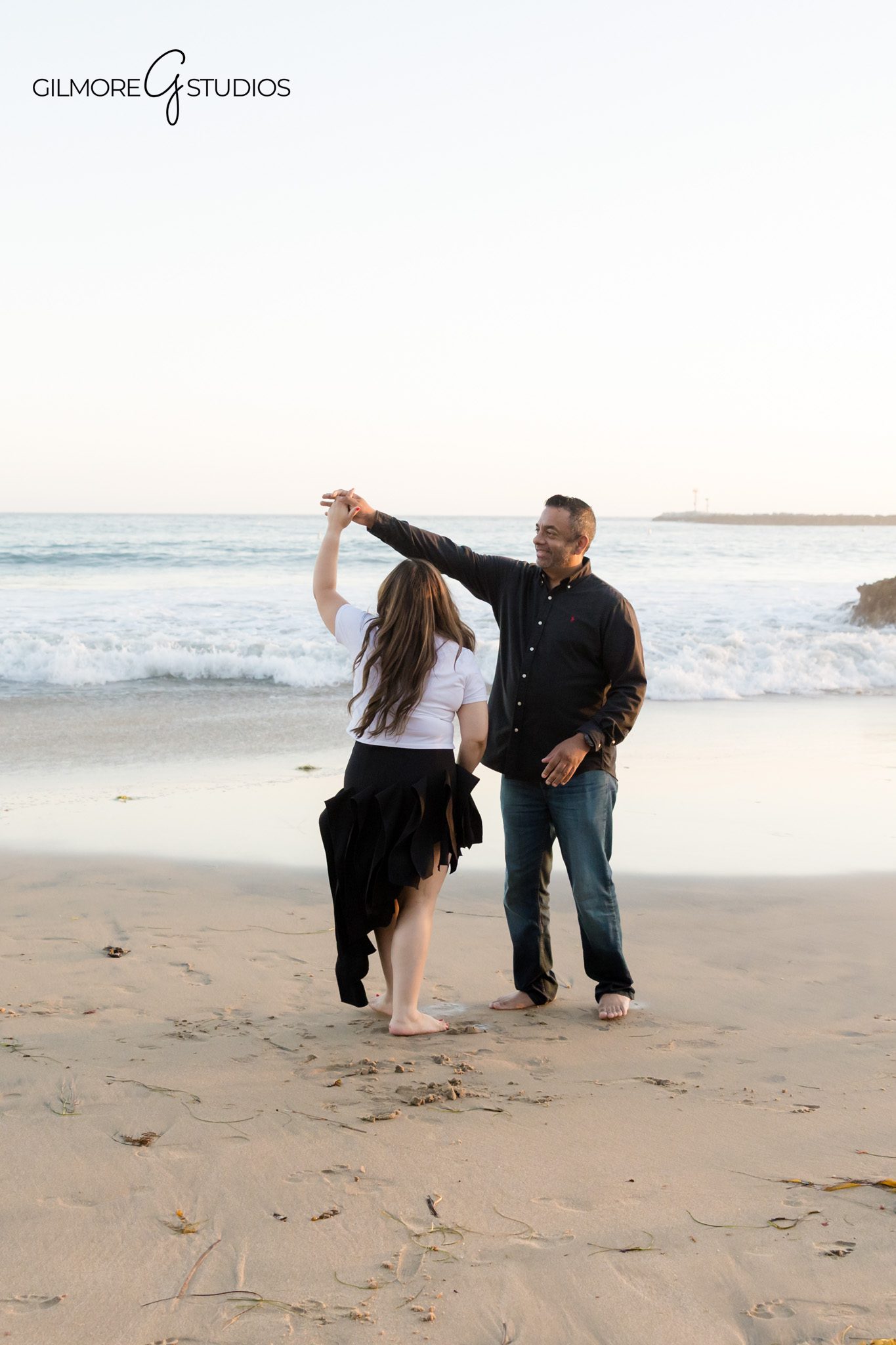 Big Corona Beach family session with natural laughter and movement
Newport Beach golden hour family photos with cliffs and shoreline