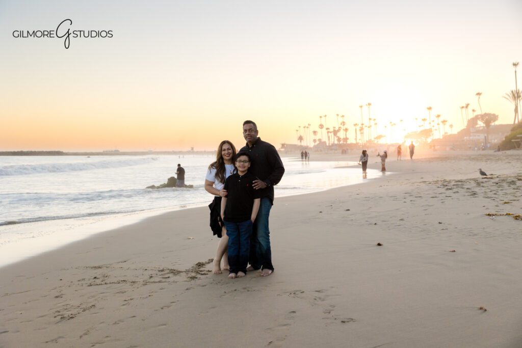 Big Corona Beach golden hour session with natural family connection
Child walking between parents during Newport Beach family photos