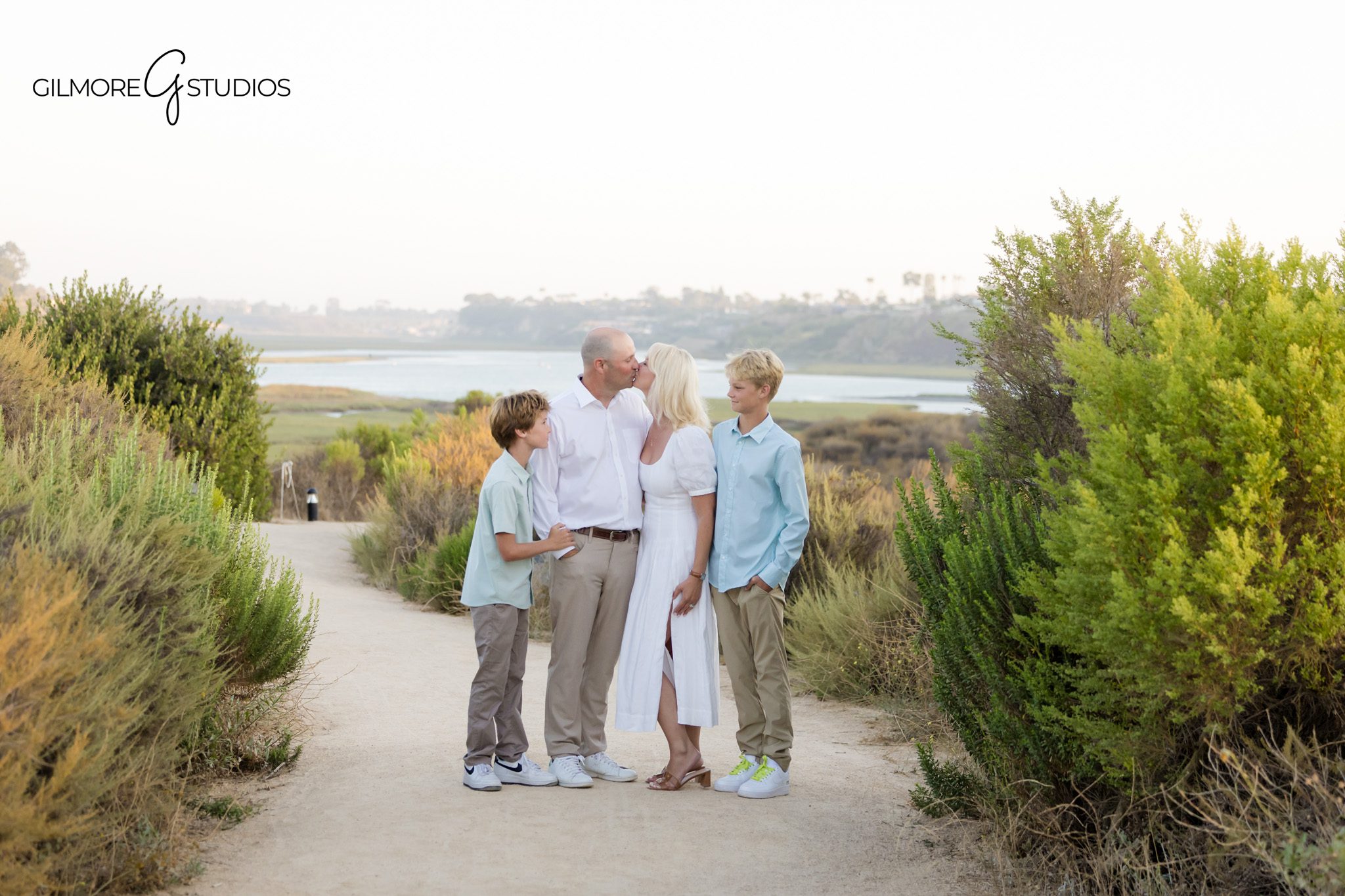 Family laughing together during Newport Beach Back Bay session
Newport Beach family photos with soft coastal neutrals