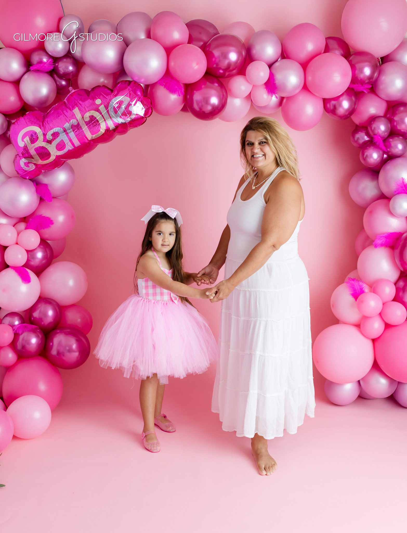 Gilbert AZ children’s photographer capturing 5th birthday portraits
Five year old girl dancing in front of Barbie inspired backdrop