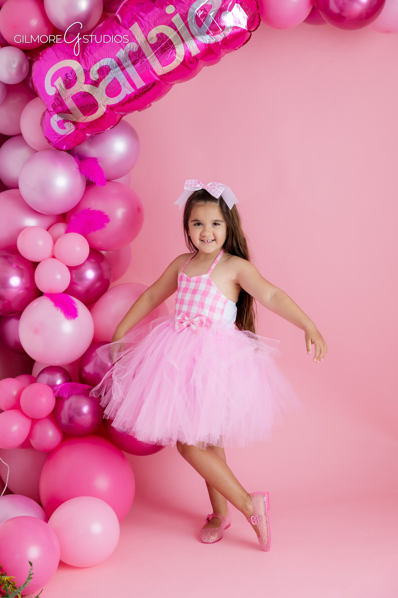 Five year old birthday photos with playful Barbie party styling
Barbie birthday cake photo with pink decorations and number five
