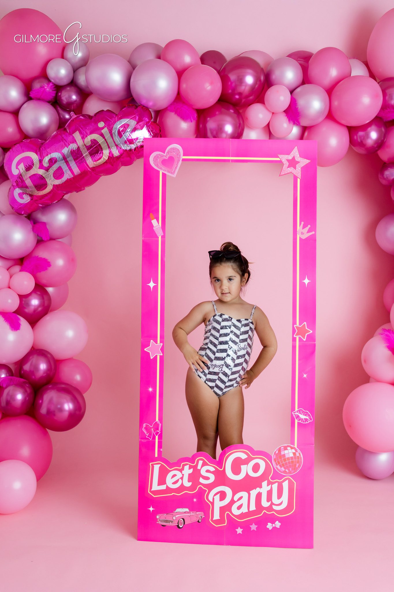 Gilbert AZ studio birthday portraits with pink fashion theme
Girl twirling during Barbie themed 5th birthday photo session