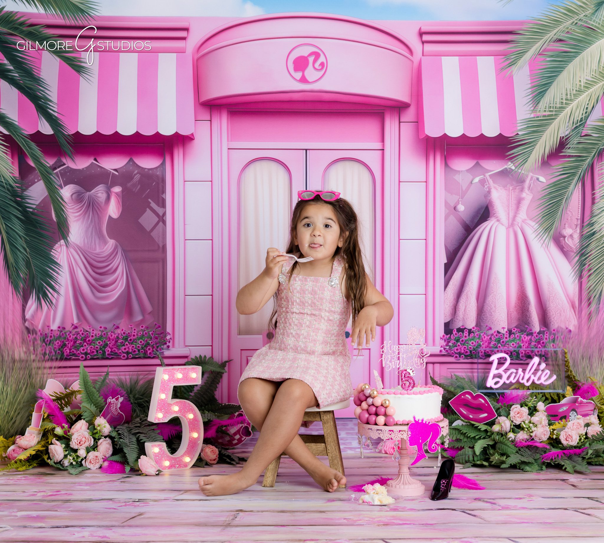 Barbie themed kids photoshoot with pink backdrop and balloons
Pink balloon birthday photo session for five year old girl