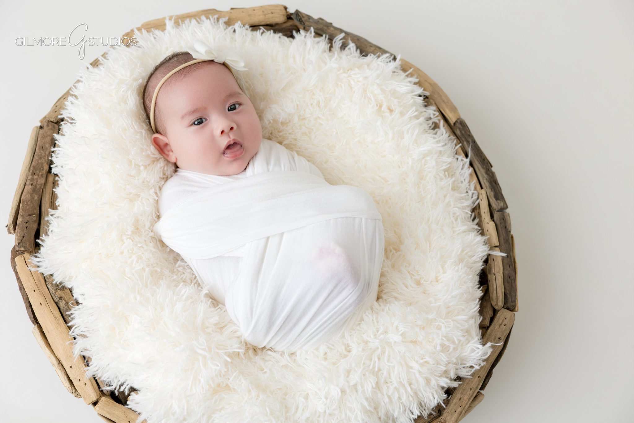 Awake baby girl portrait during Queen Creek newborn photo session
Older newborn baby photo with soft pink outfit and white background
