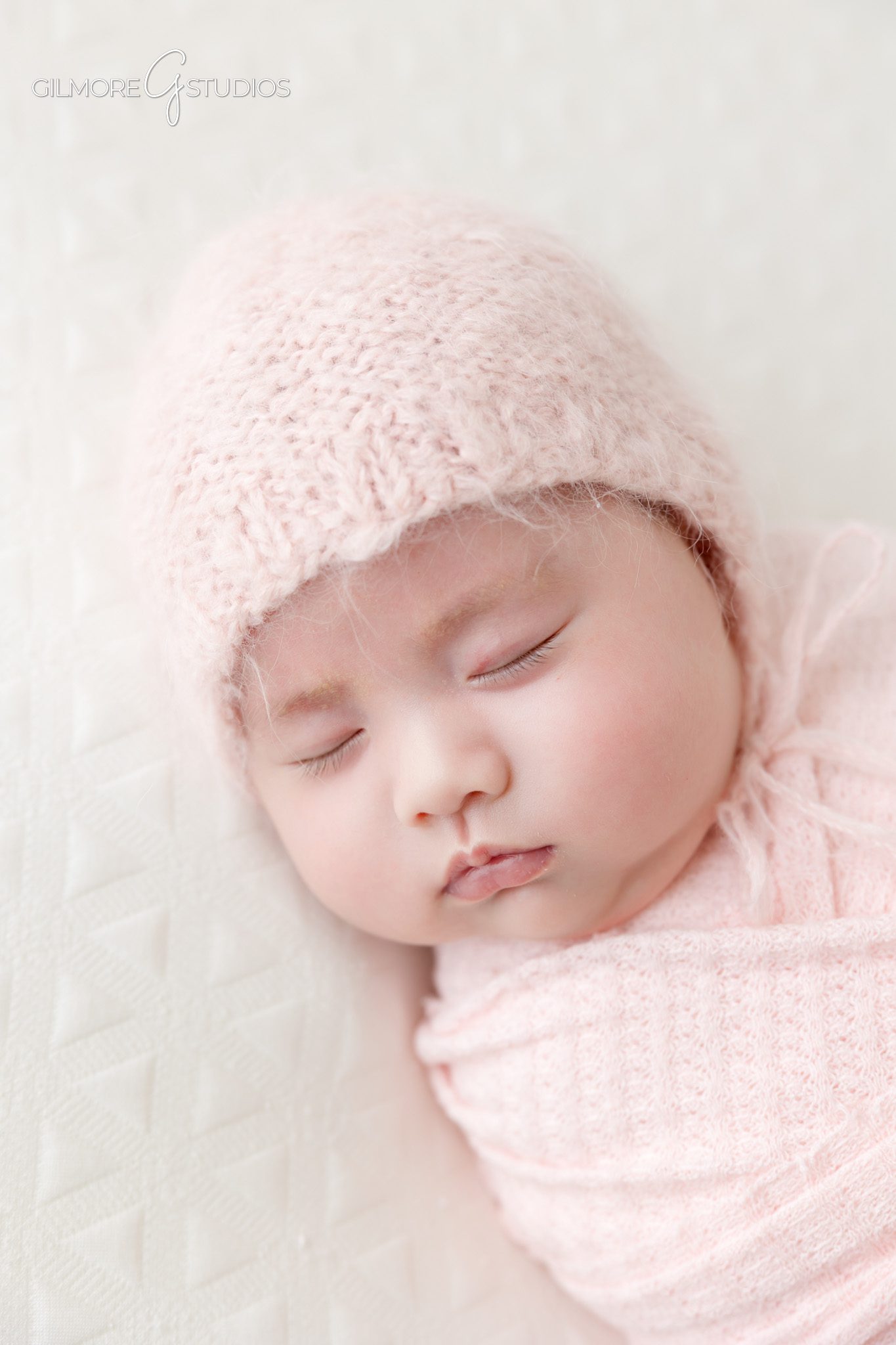 Queen Creek baby photographer capturing older newborn session with family
Baby girl sitting with dad and big brother during studio newborn photos