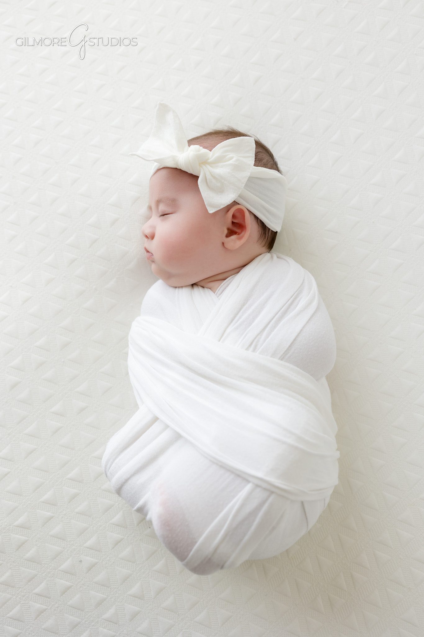 Older newborn photos in Queen Creek AZ with simple white background
Dad holding baby girl during 2 month old newborn photography session
