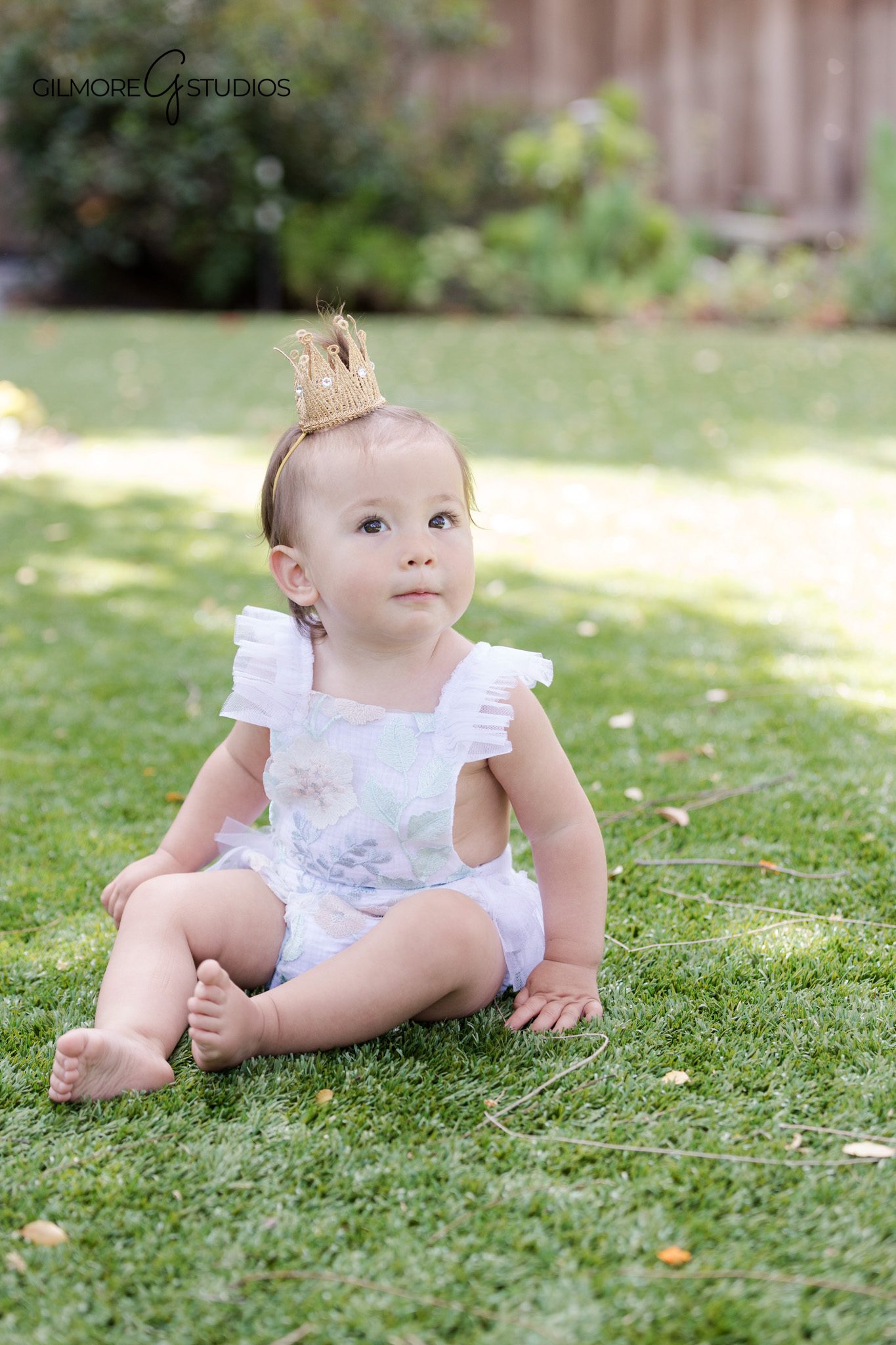 Parents playing with baby girl during first birthday portrait session
Natural outdoor baby milestone photos by Gilmore Studios