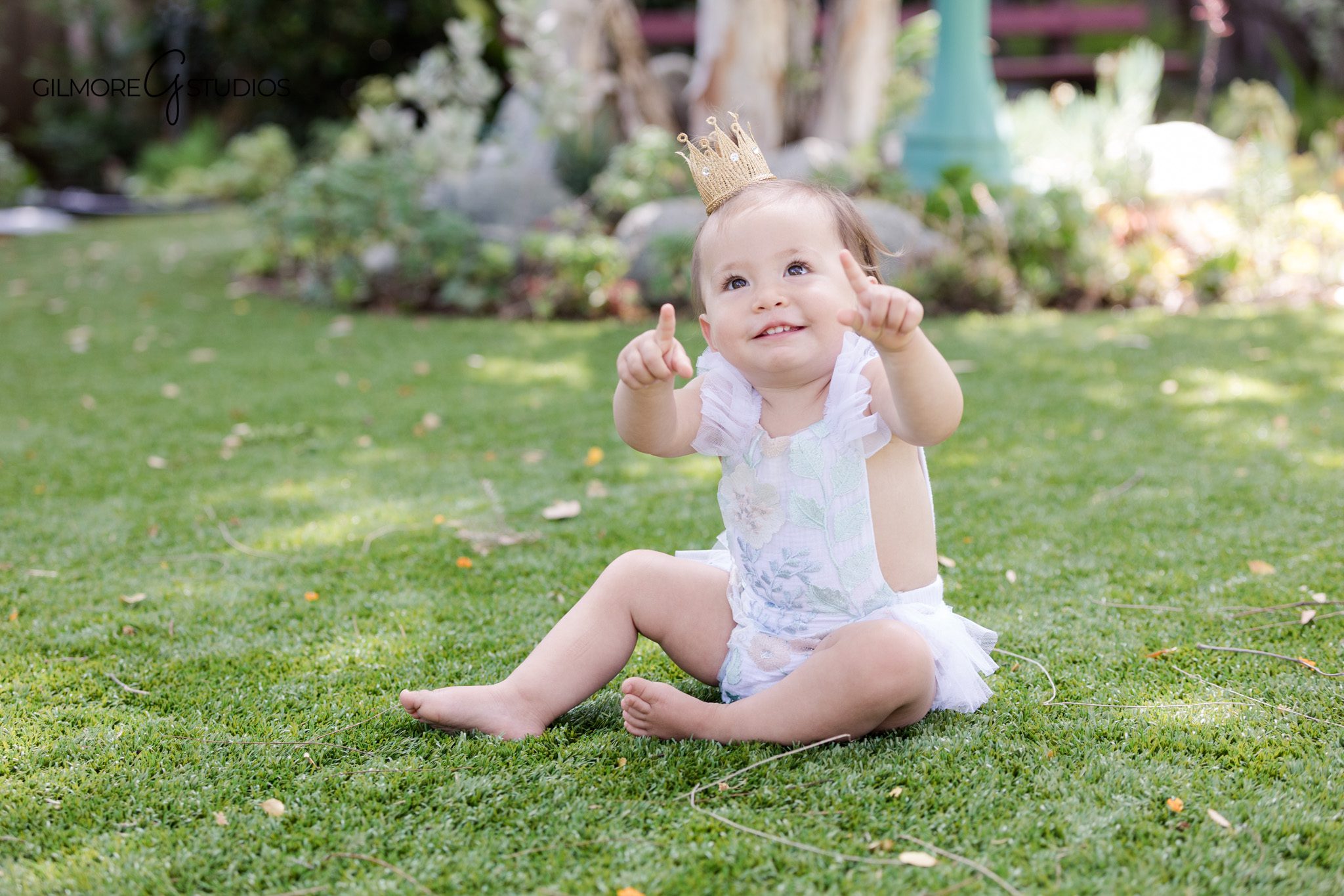 Pearl and mermaid first birthday setup with pastel ocean backdrop
Baby girl smiling on under the sea birthday set in Newport Beach