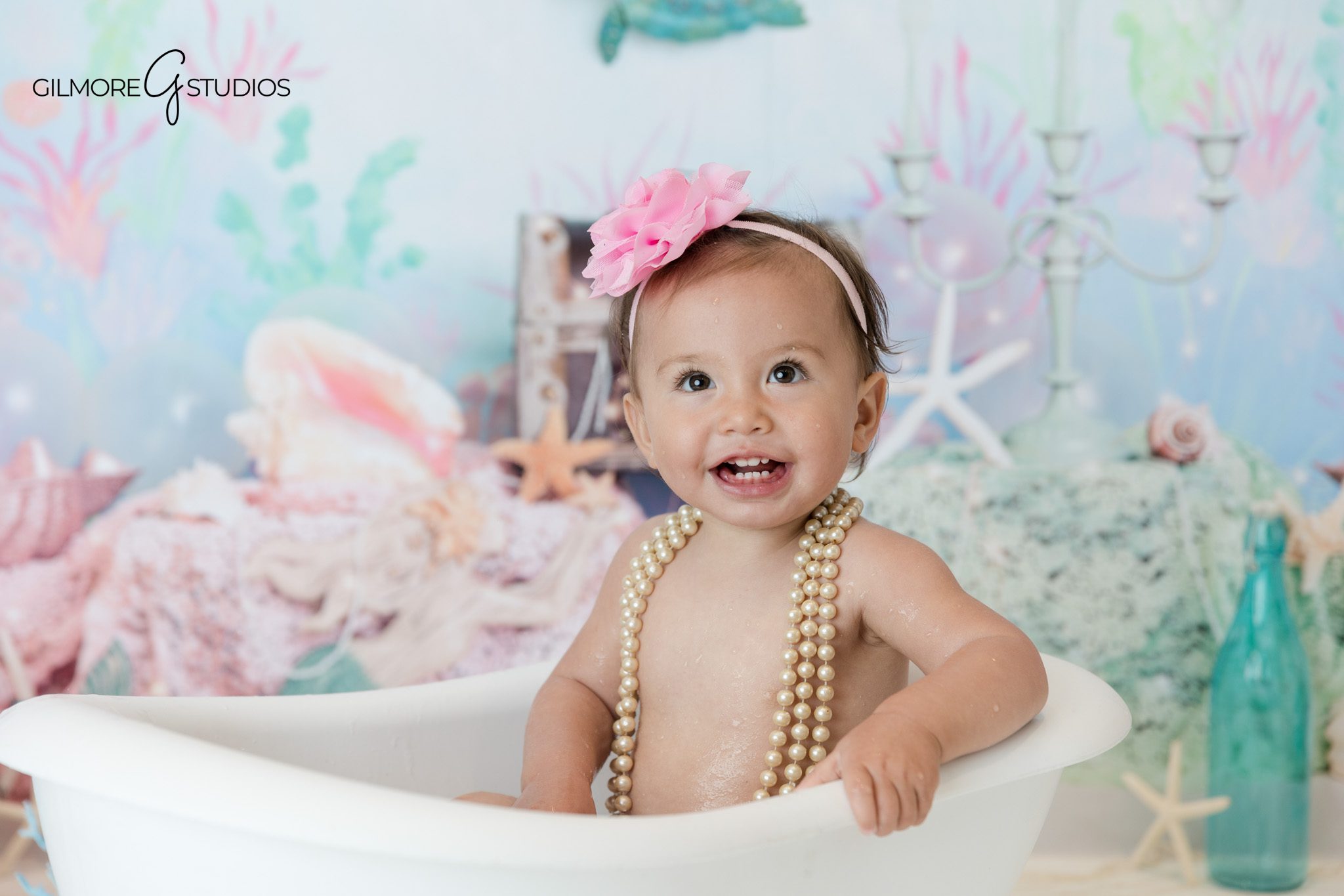 Newport Beach first birthday cake smash photographer with ocean theme
Pink and aqua cake smash setup for baby girl birthday portraits