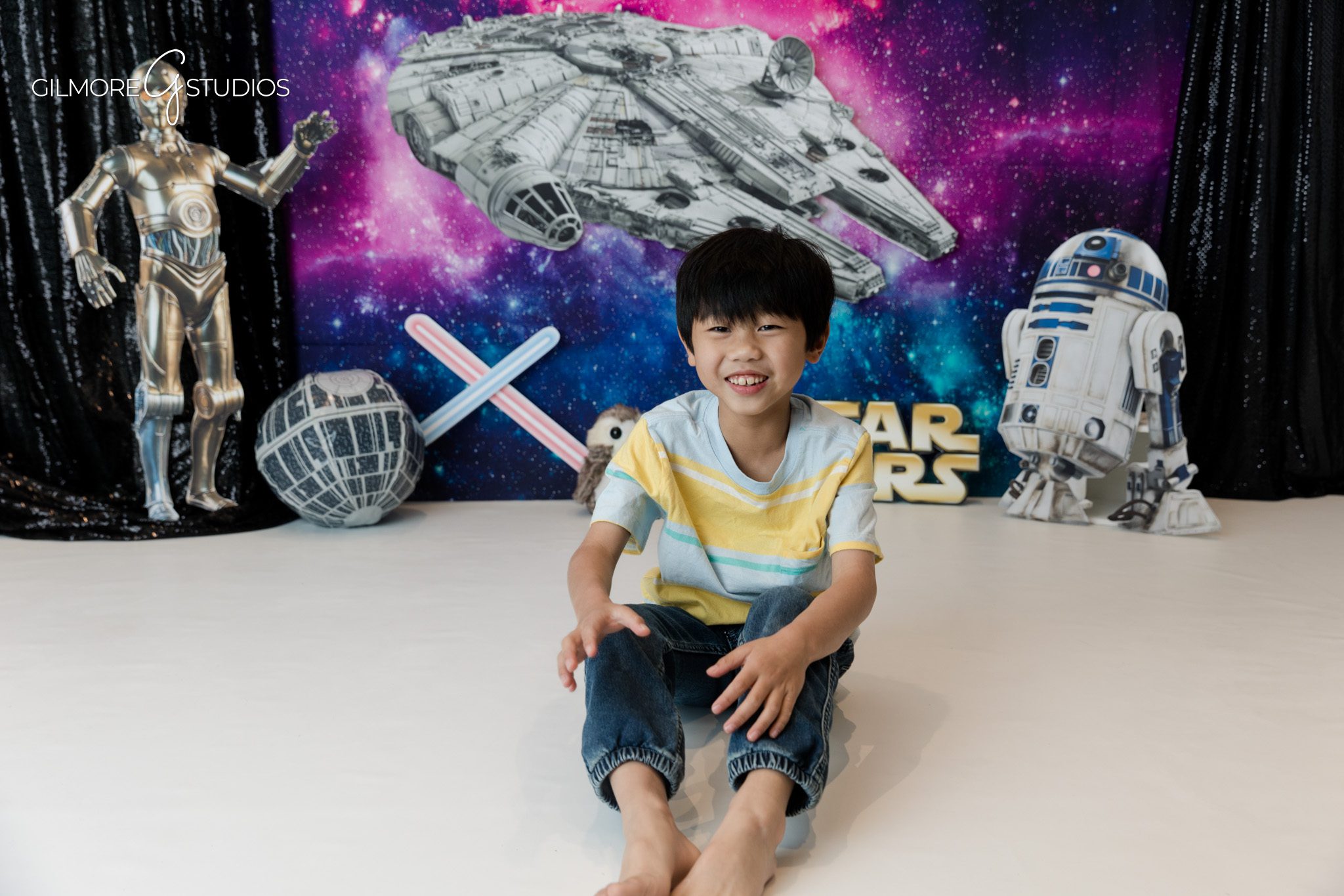 Boy posing on studio floor for space themed birthday photos
Newport Beach kids photo session with fun birthday set