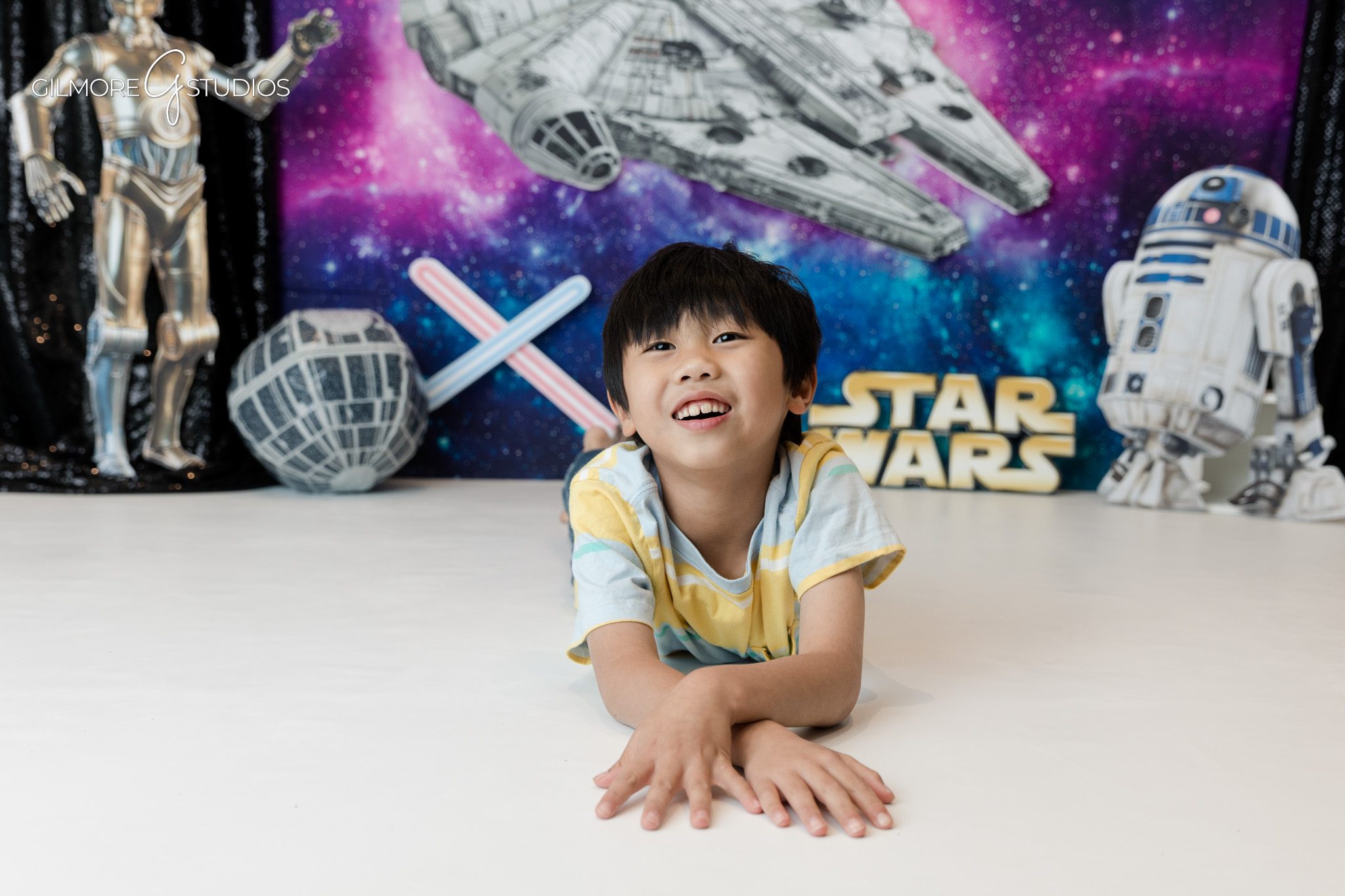 Child smiling during space themed birthday photo session
Themed birthday portraits for kids in Newport Beach