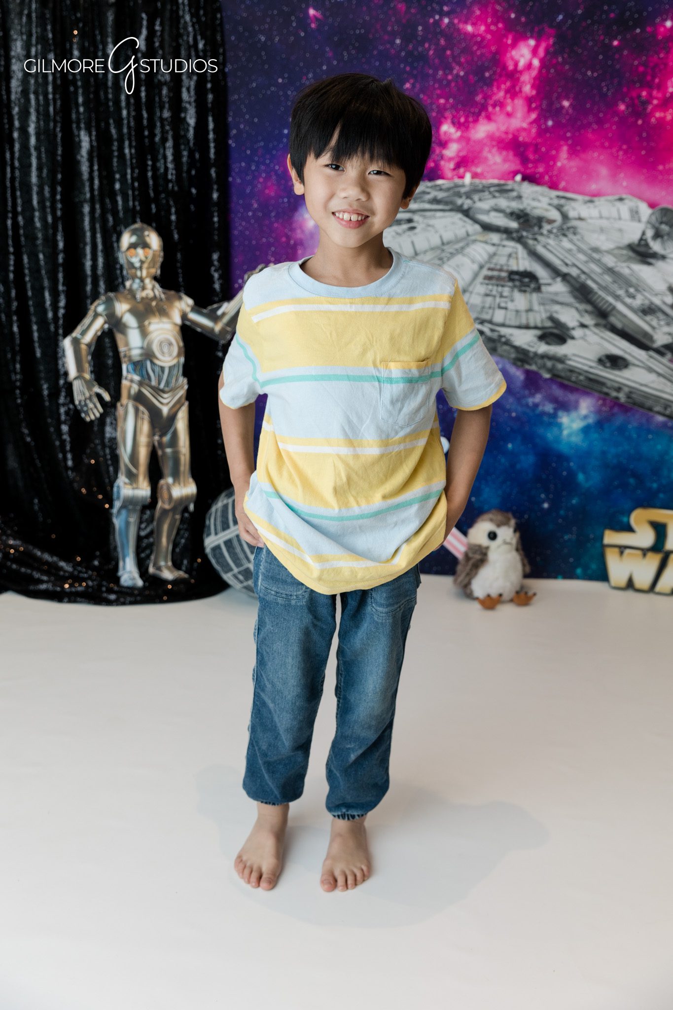 Gilmore Studios kids birthday photos with galaxy themed setup
Child sitting in front of space themed birthday backdrop
