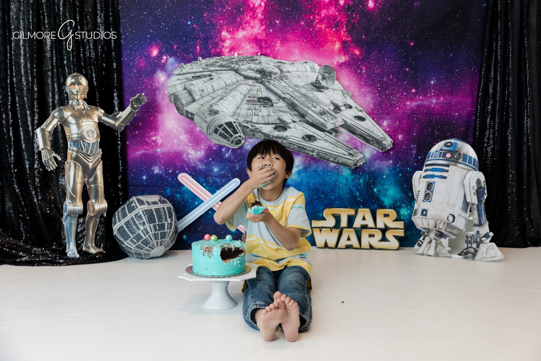 Space themed child portrait with galaxy colors and movie inspired props
Kids portrait session with spaceship backdrop and playful expression