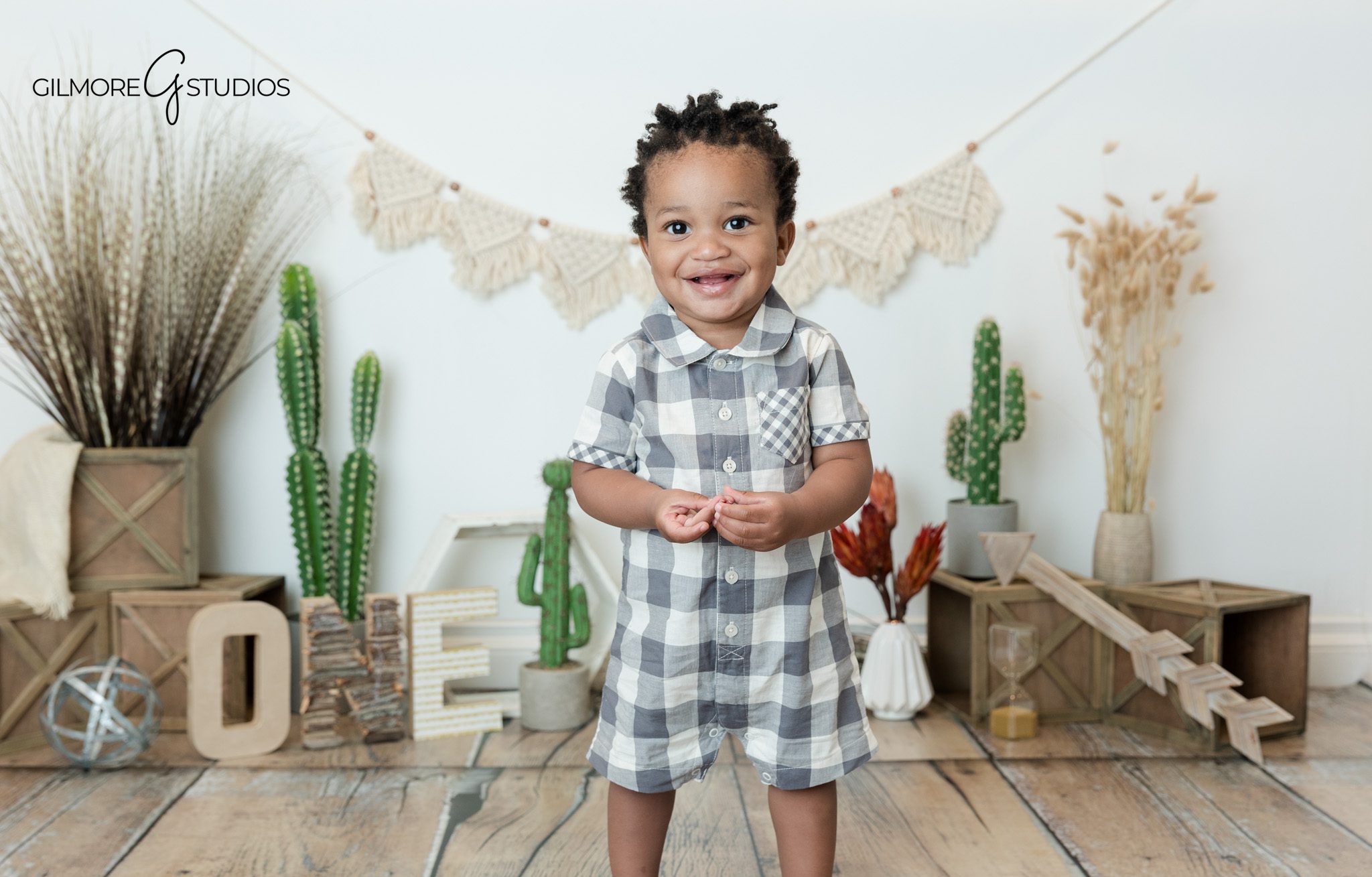 Outdoor baby photos before studio cake smash session
Baby boy standing barefoot during first birthday photos