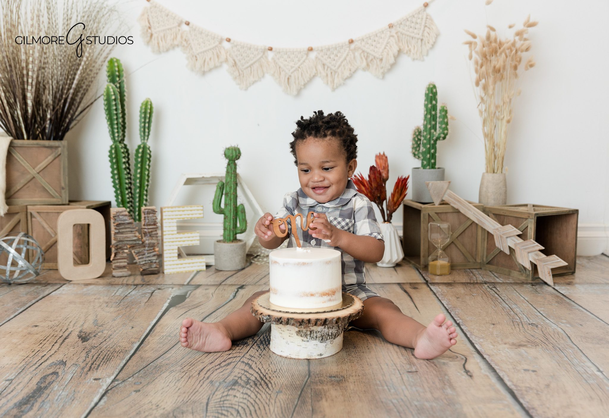 Boho cake smash photos in Newport Beach with baby boy standing in garden
Newport Beach first birthday photographer capturing outdoor baby portraits