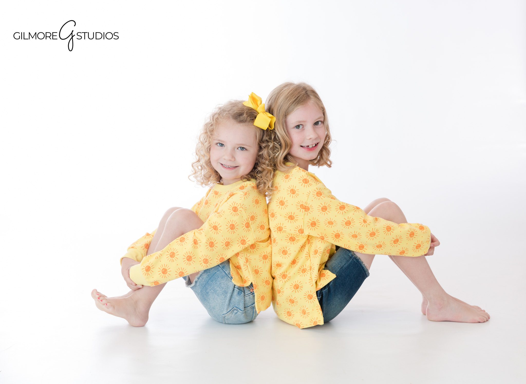 Studio sibling session with sisters sitting close together
Matching dresses for sisters during Newport Beach studio photos