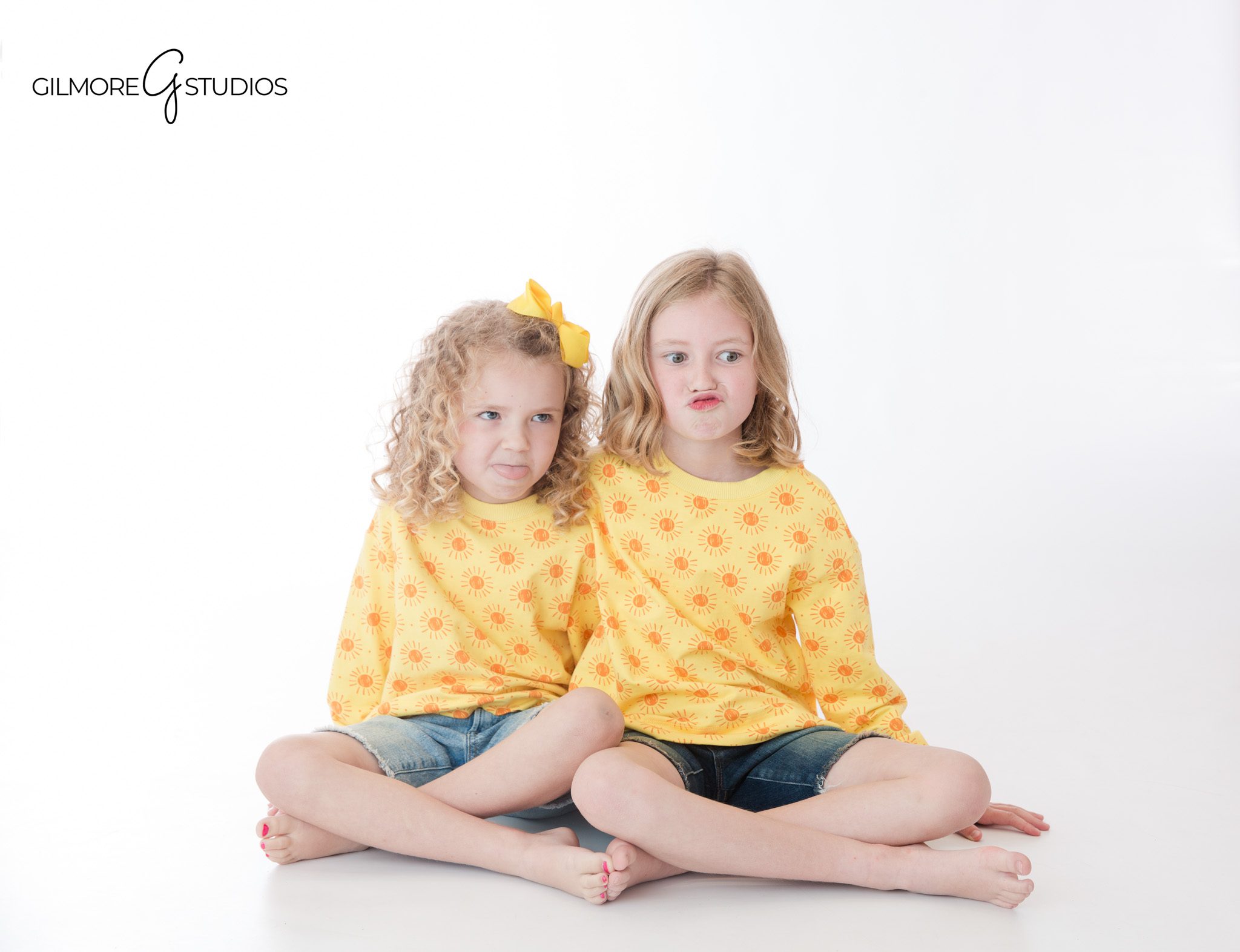 Gilmore Studios children’s photographer capturing sibling connection
Sisters in matching blue dresses during studio portrait session