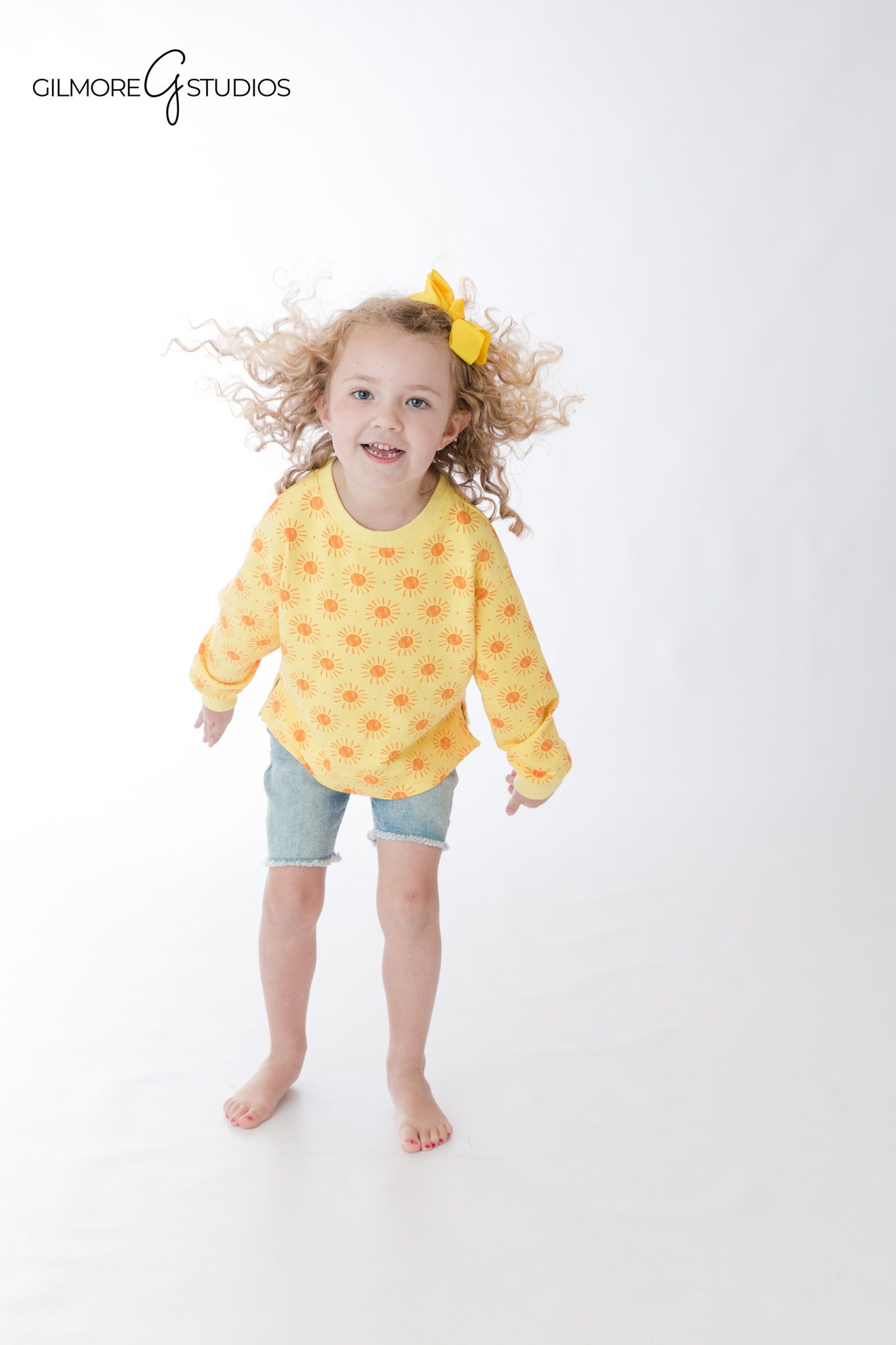 Matching sibling outfits for a white studio portrait session
Sisters posing together for classic Newport Beach children’s photos